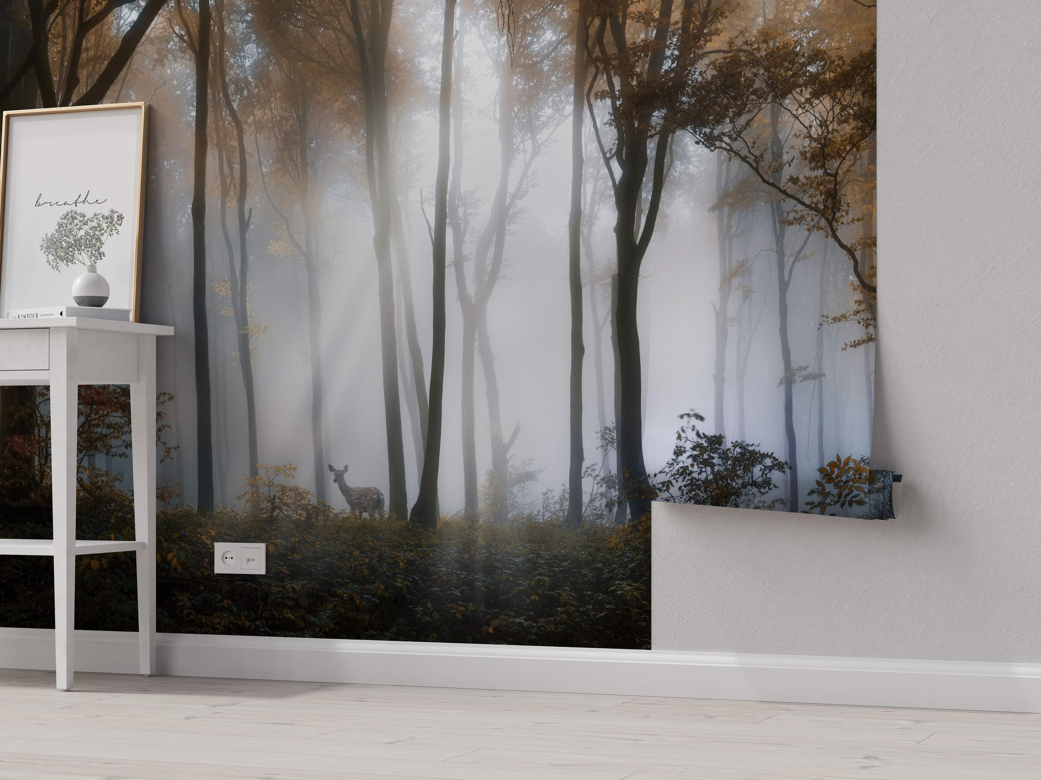 Mural depicting a misty forest scene with tall brown trees, golden leaves, and a deer in shades of gray and brown.