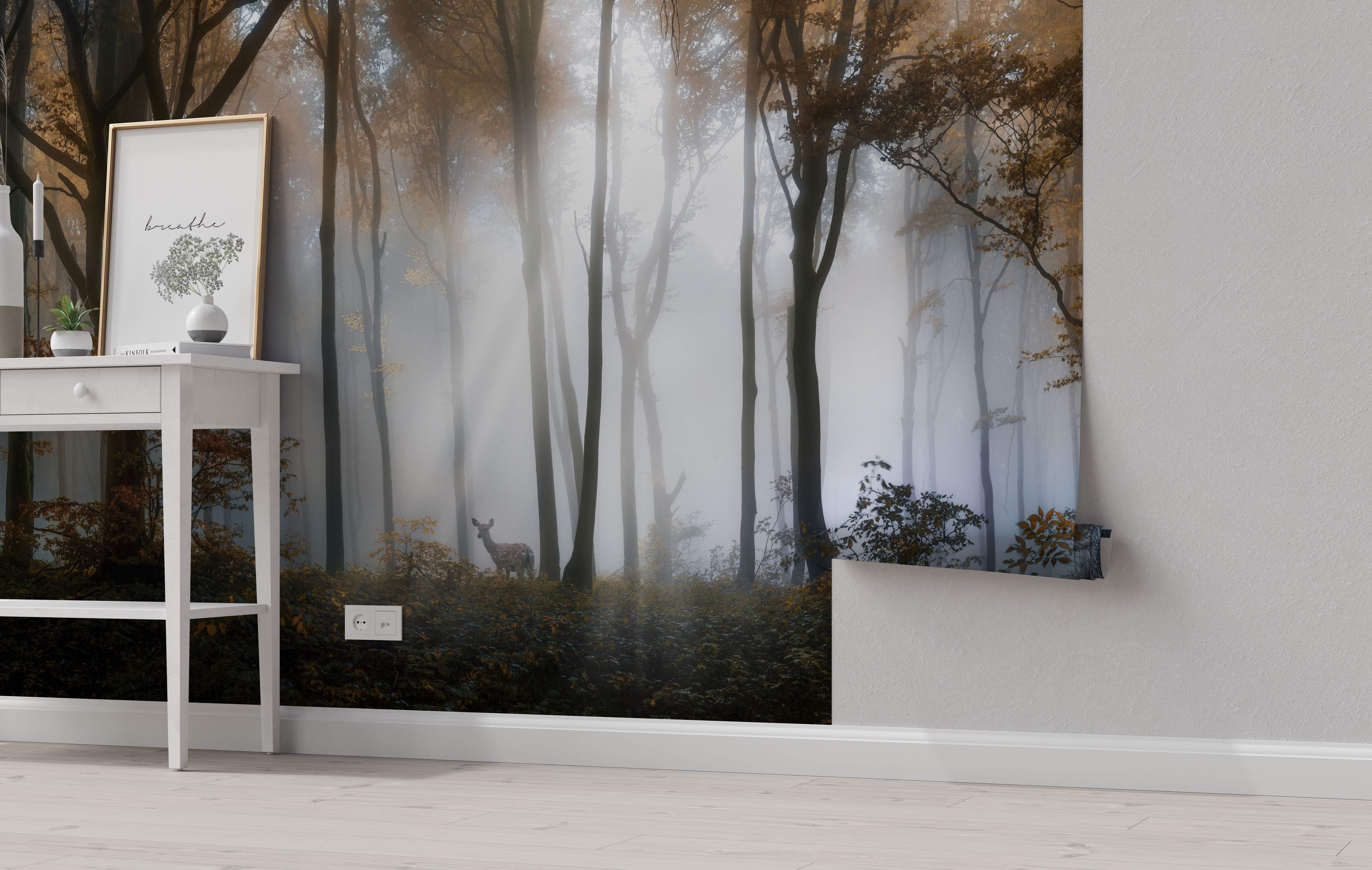Mural depicting a misty forest scene with tall brown trees, golden leaves, and a deer in shades of gray and brown.