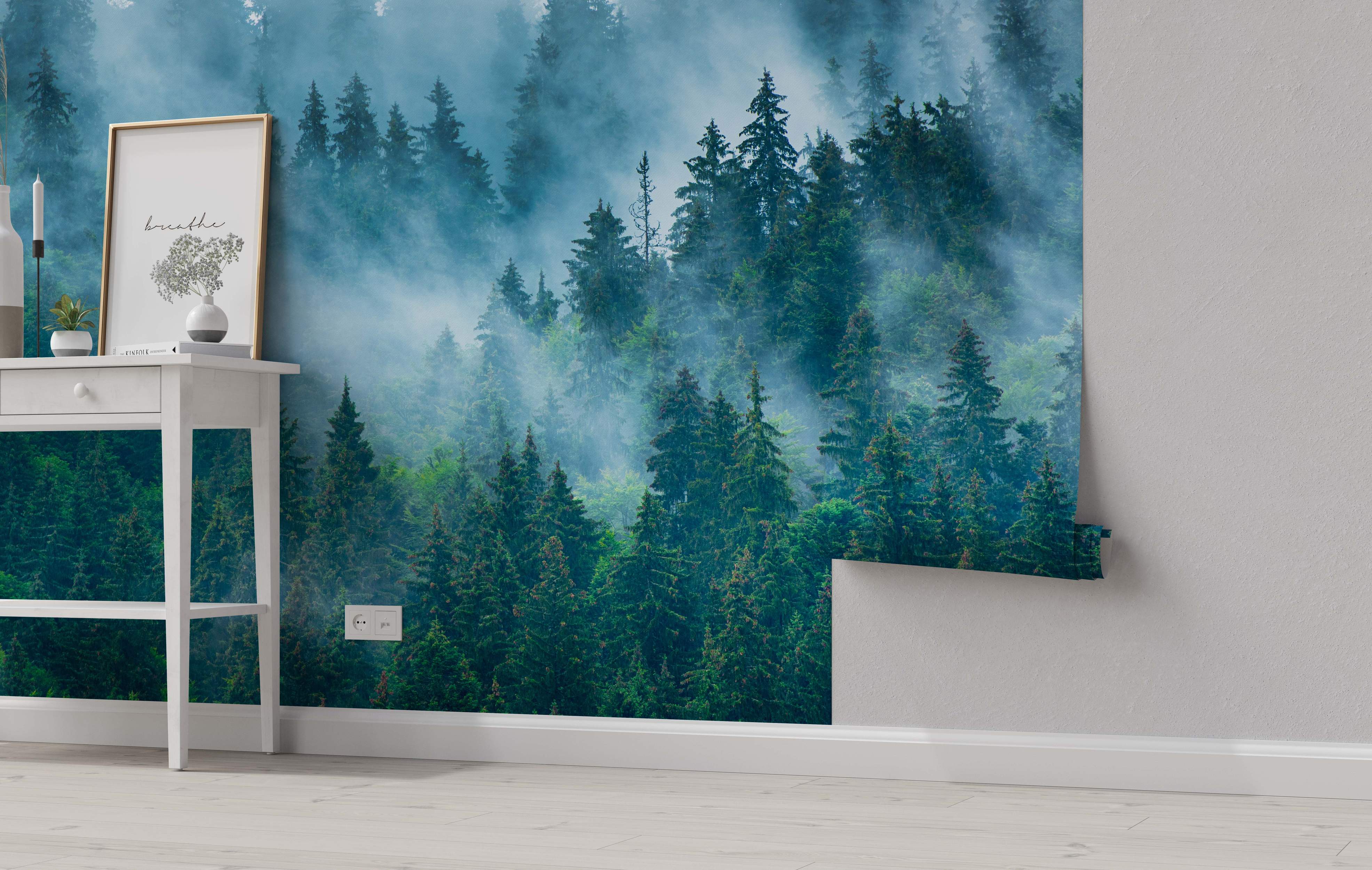 Mural depicting a dense forest of tall green pine trees shrouded in blue-gray fog.