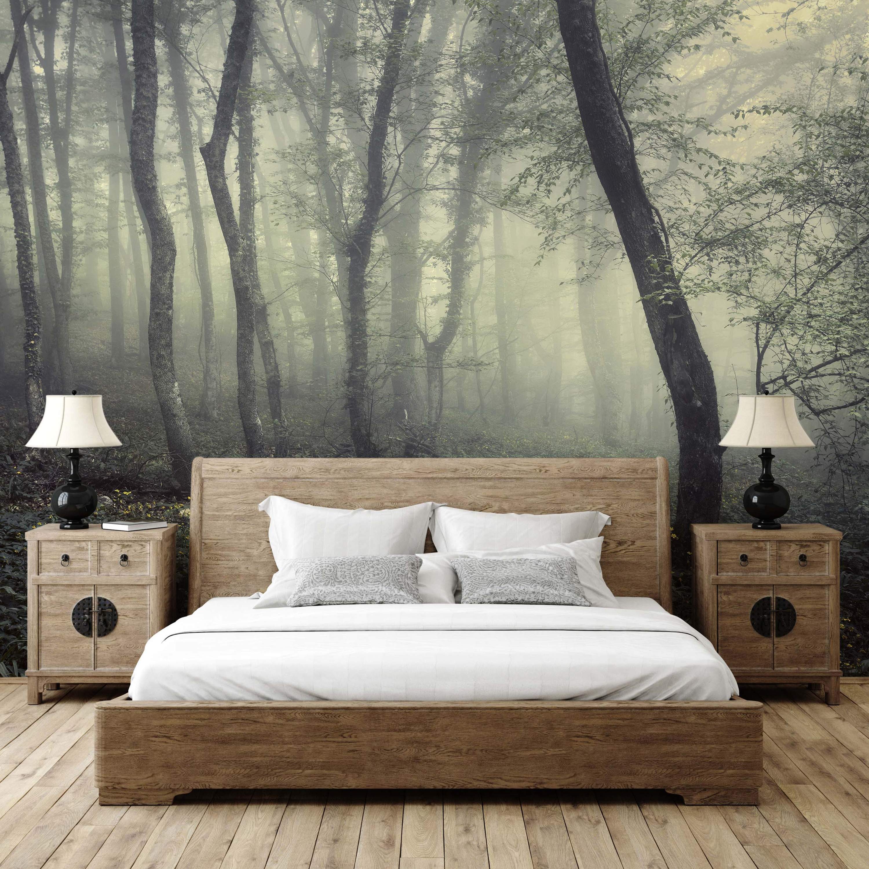 Mural depicting a misty forest scene with tall trees in shades of gray and green, with subtle light filtering through.