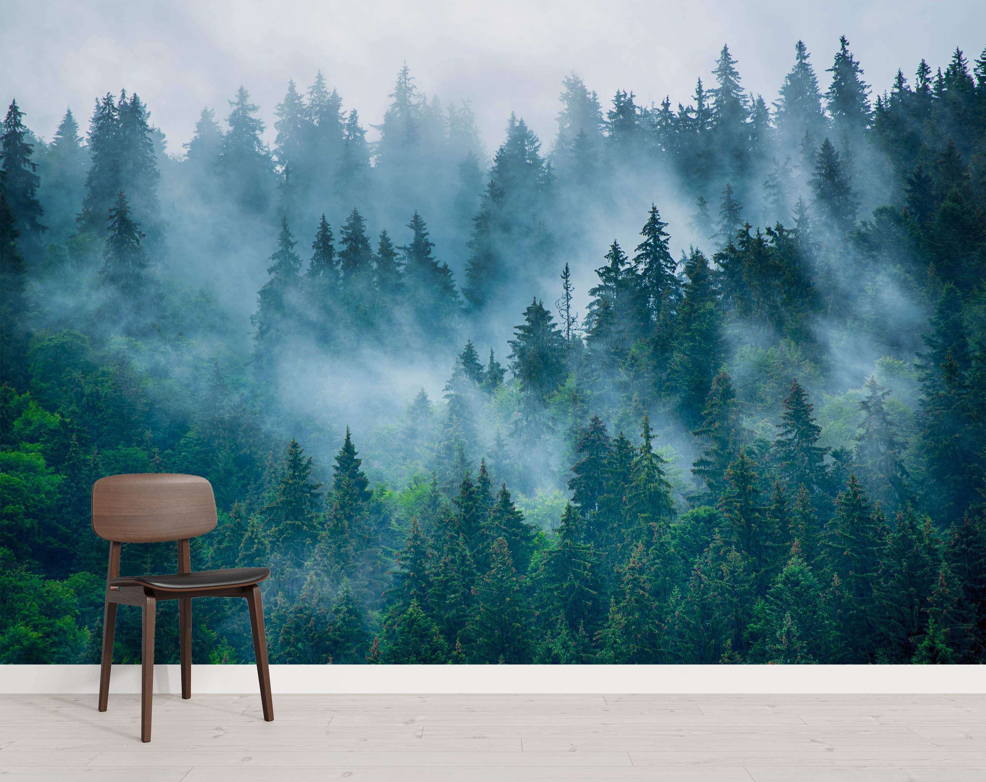 Mural featuring a dense evergreen forest scene with tall green pine trees partially obscured by swirling blue-gray fog.