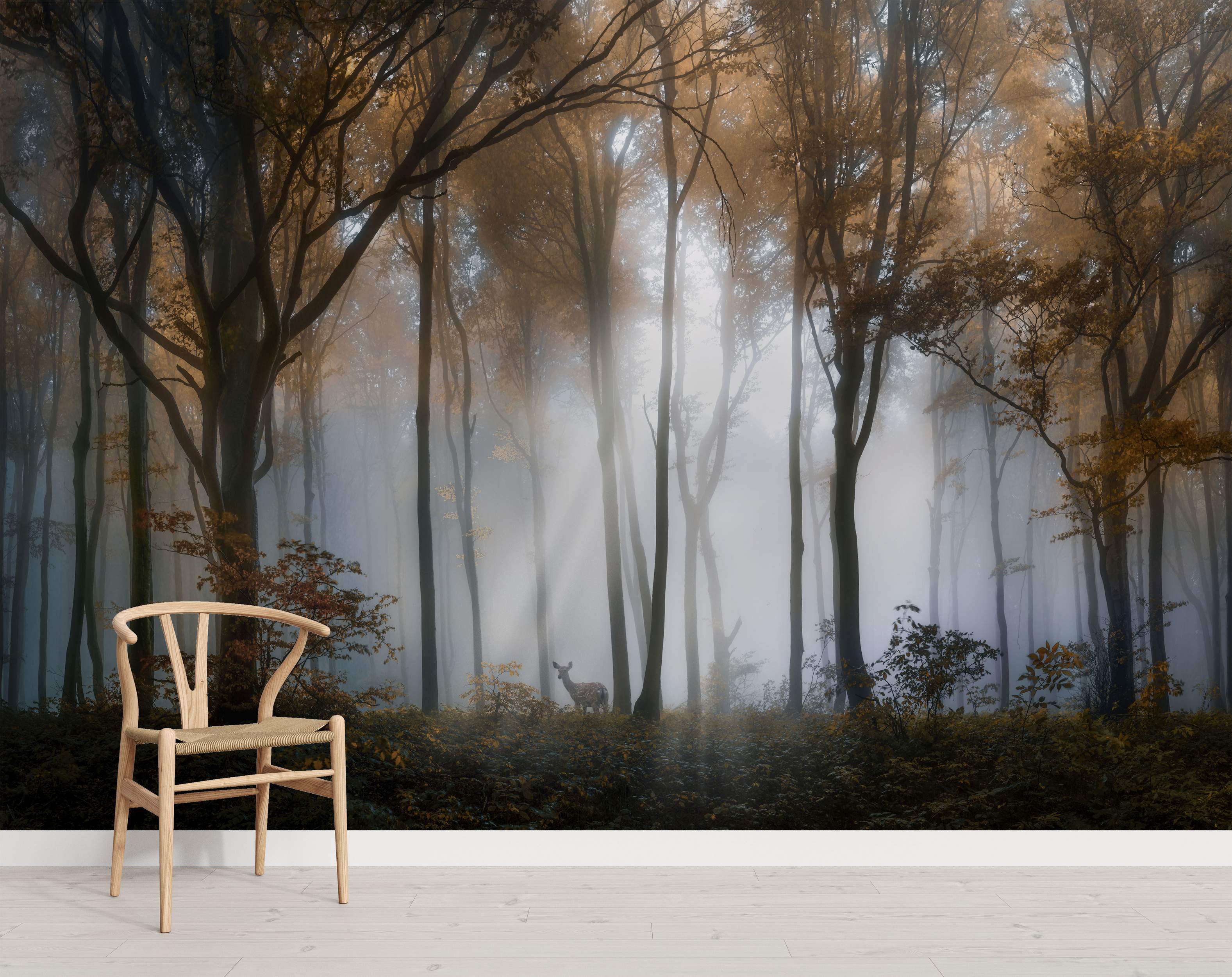 Mural depicting a misty autumn forest with tall, golden-leaved trees, visible sunbeams, and a central deer.