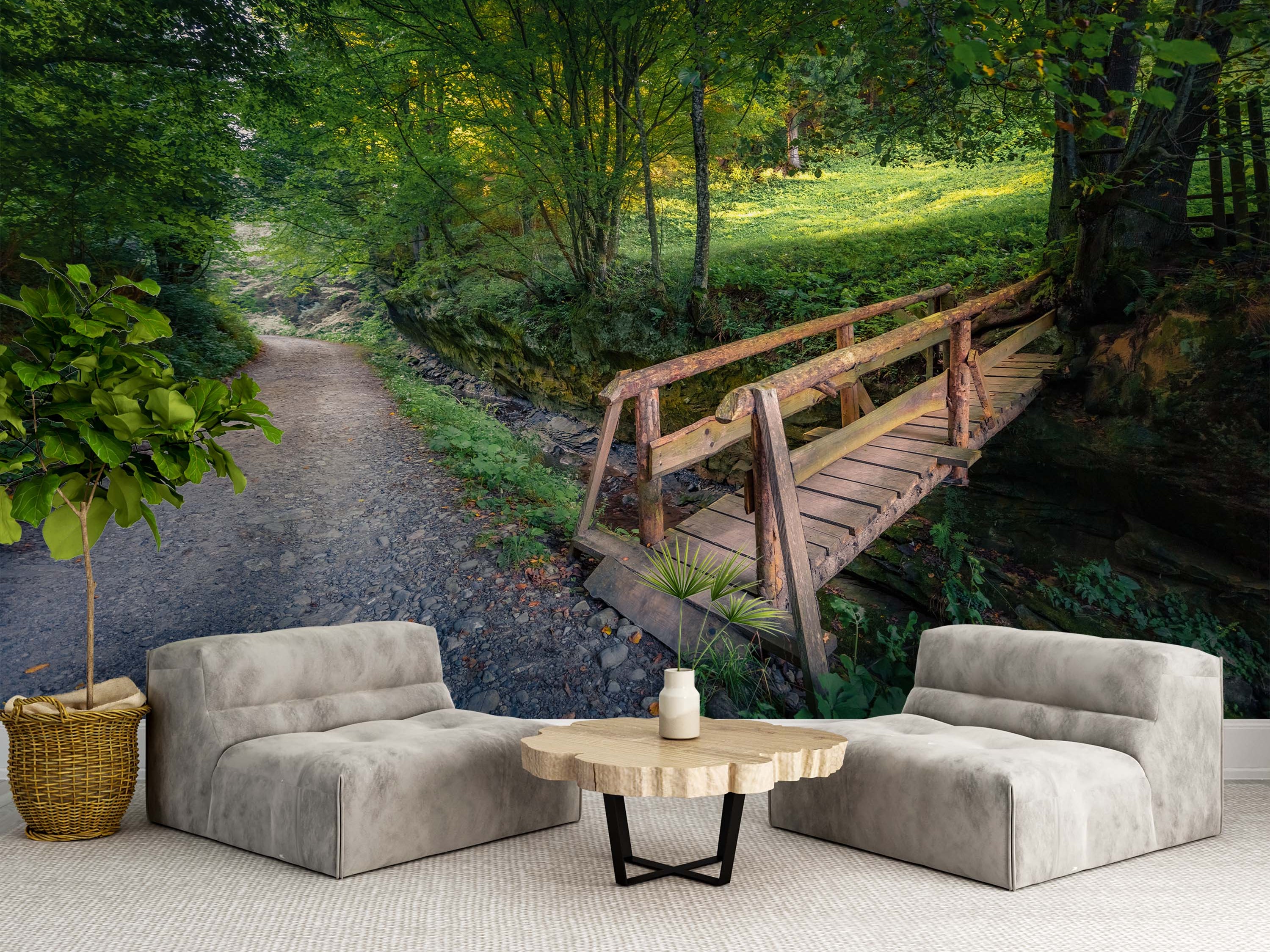 A scenic forest mural depicting a rustic wooden bridge over a creek, with a dirt path leading into lush green woods.