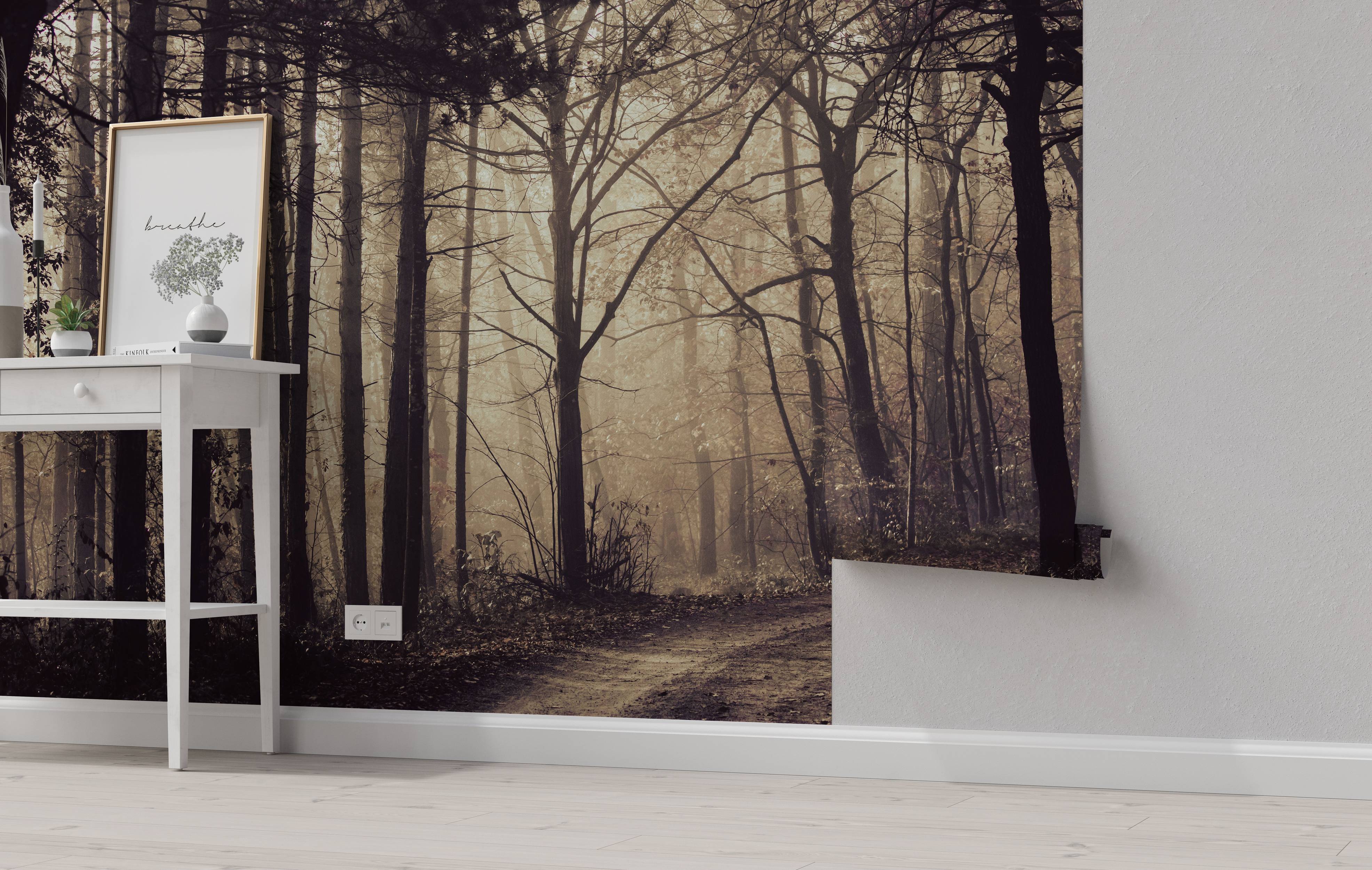 A sepia-toned mural of a dirt path winding through a dense, foggy forest with tall, bare trees creating a moody scene.