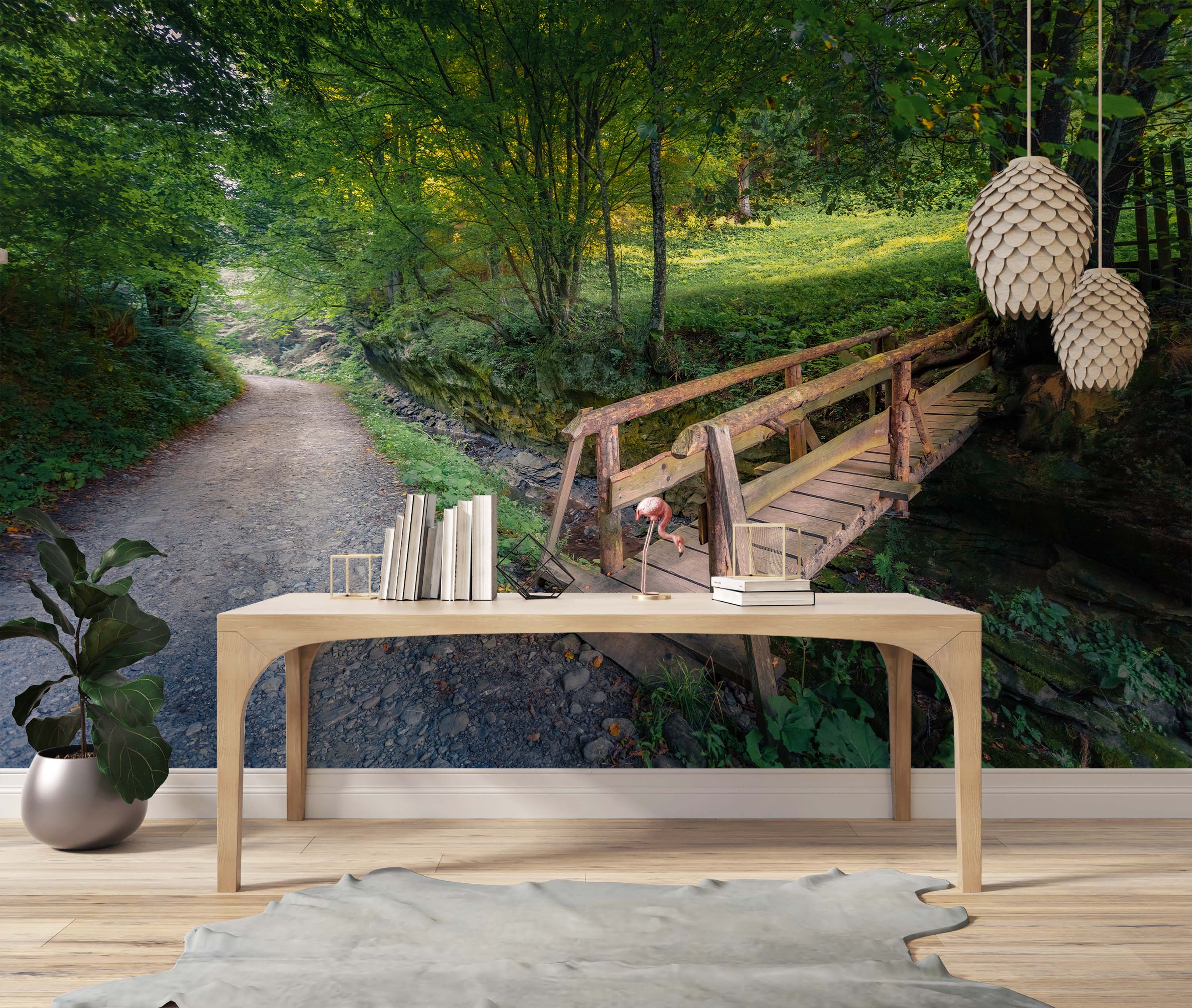 A photorealistic mural of a tranquil forest path leading over a rustic wooden footbridge surrounded by lush green trees.