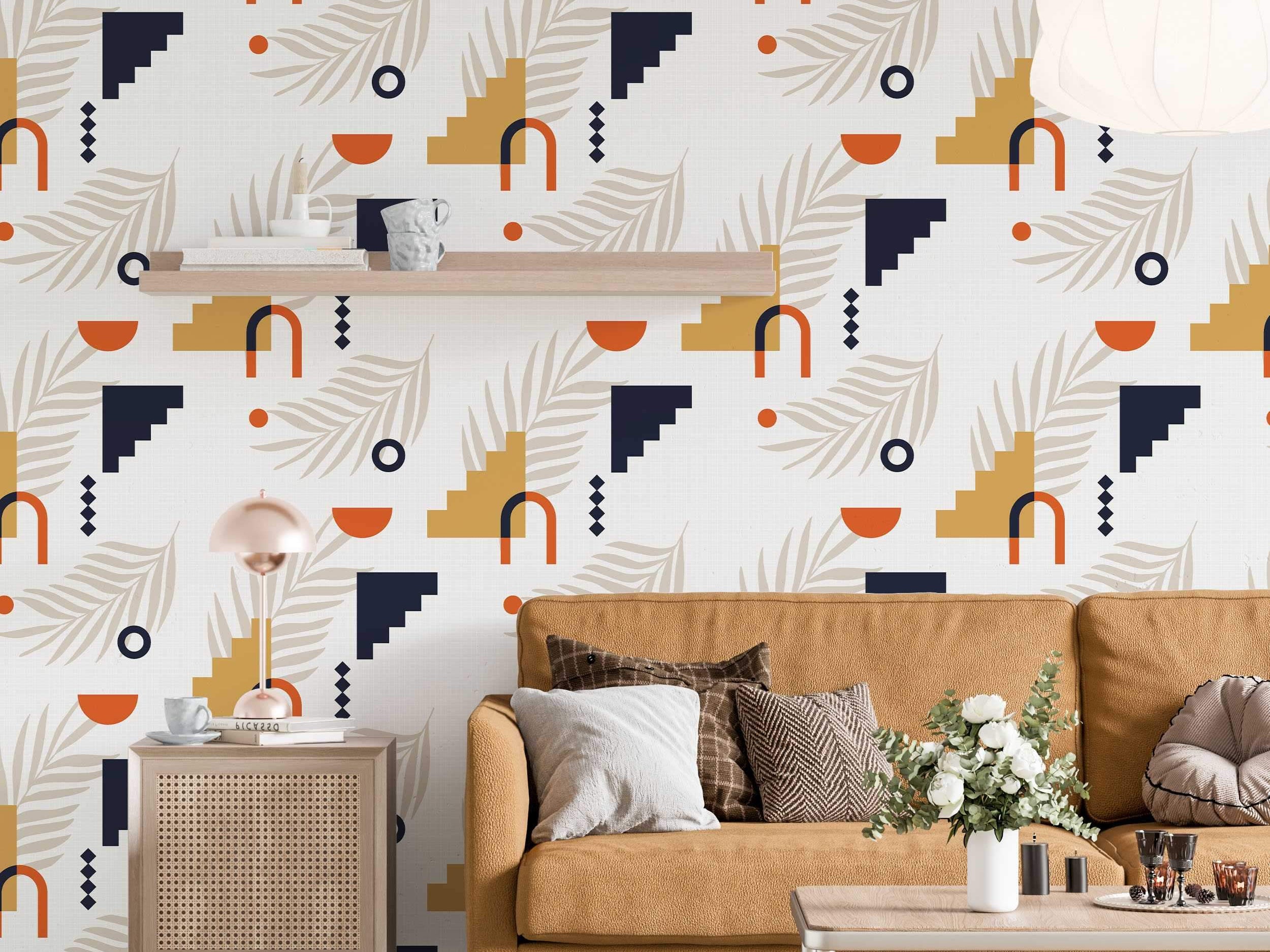 Abstract geometric wallpaper with orange arches, blue/yellow steps, beige leaves, and dots on a light background.