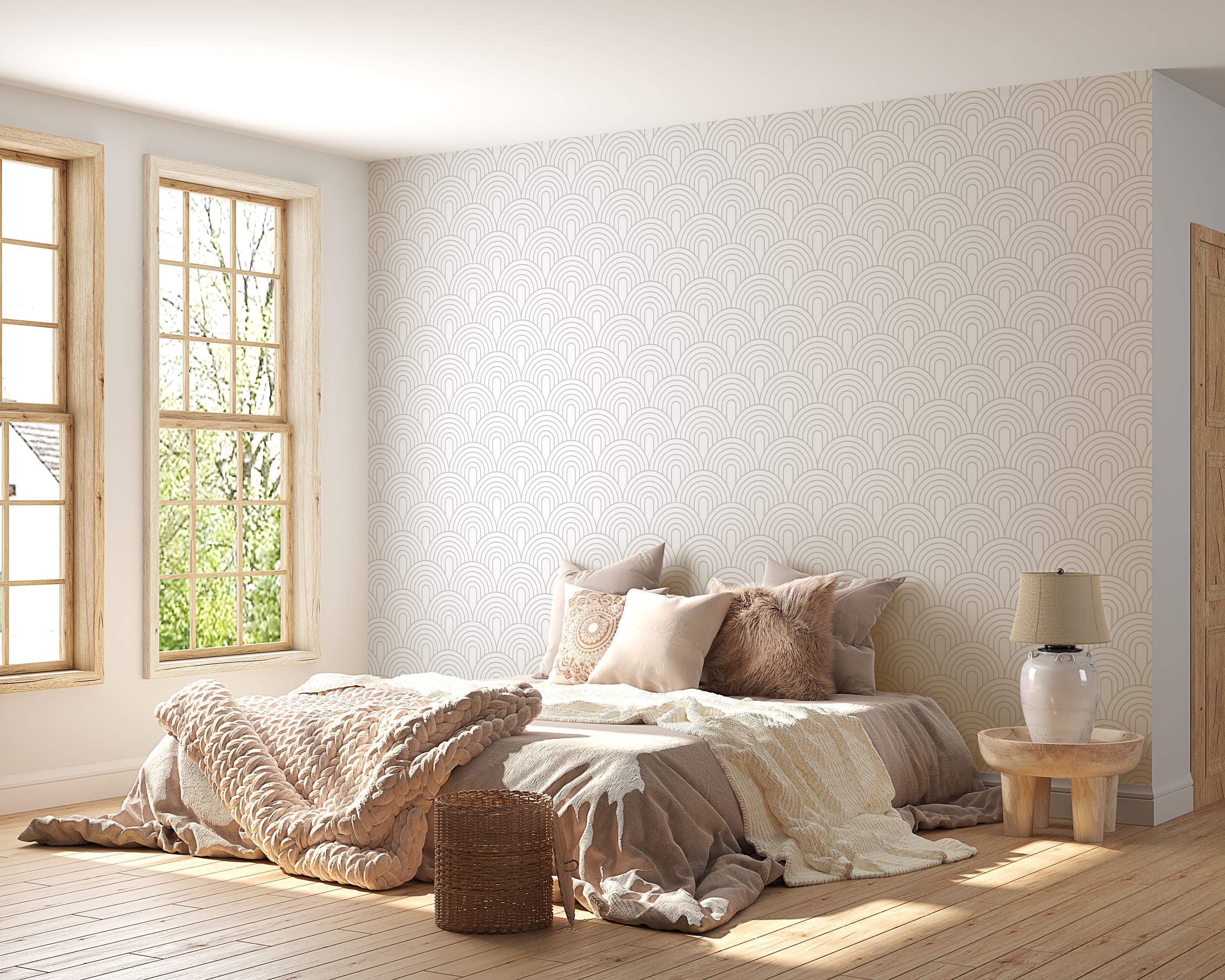 Geometric wallpaper featuring repeating light gray concentric arches on a pale beige background.