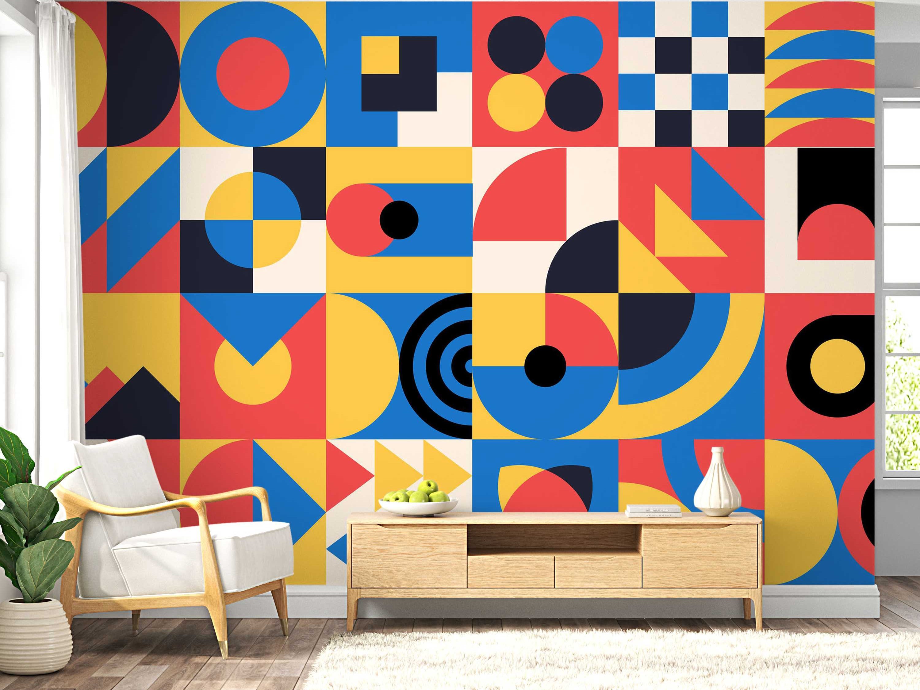 Geometric block mural featuring circles, squares, and triangles in bold blue, red, yellow, black, and cream.