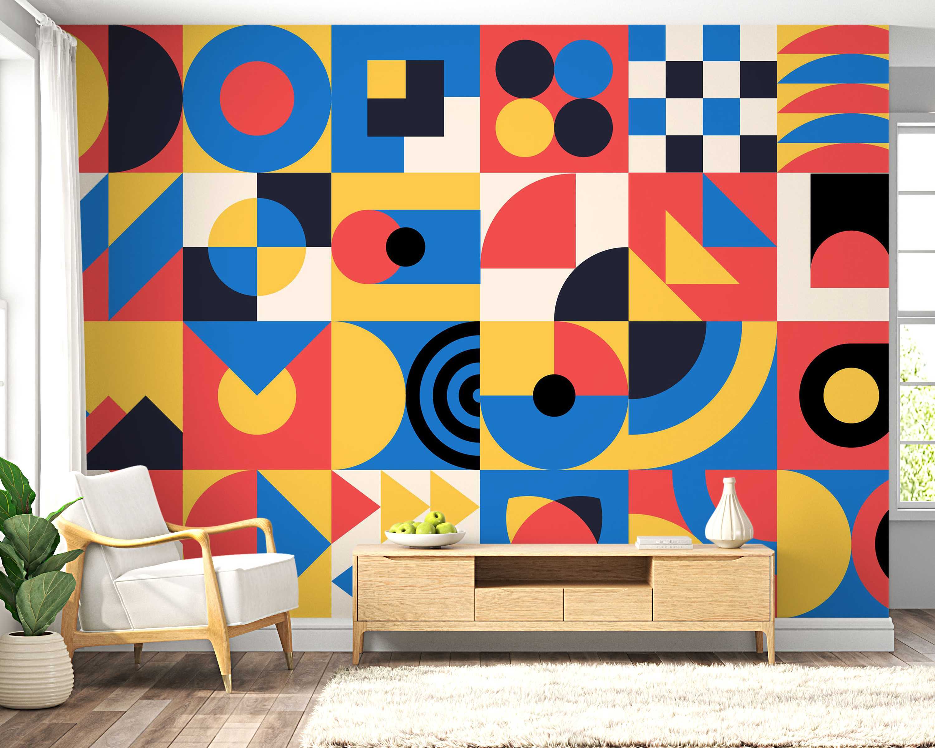 Geometric block mural featuring circles, squares, and triangles in bold blue, red, yellow, black, and cream.