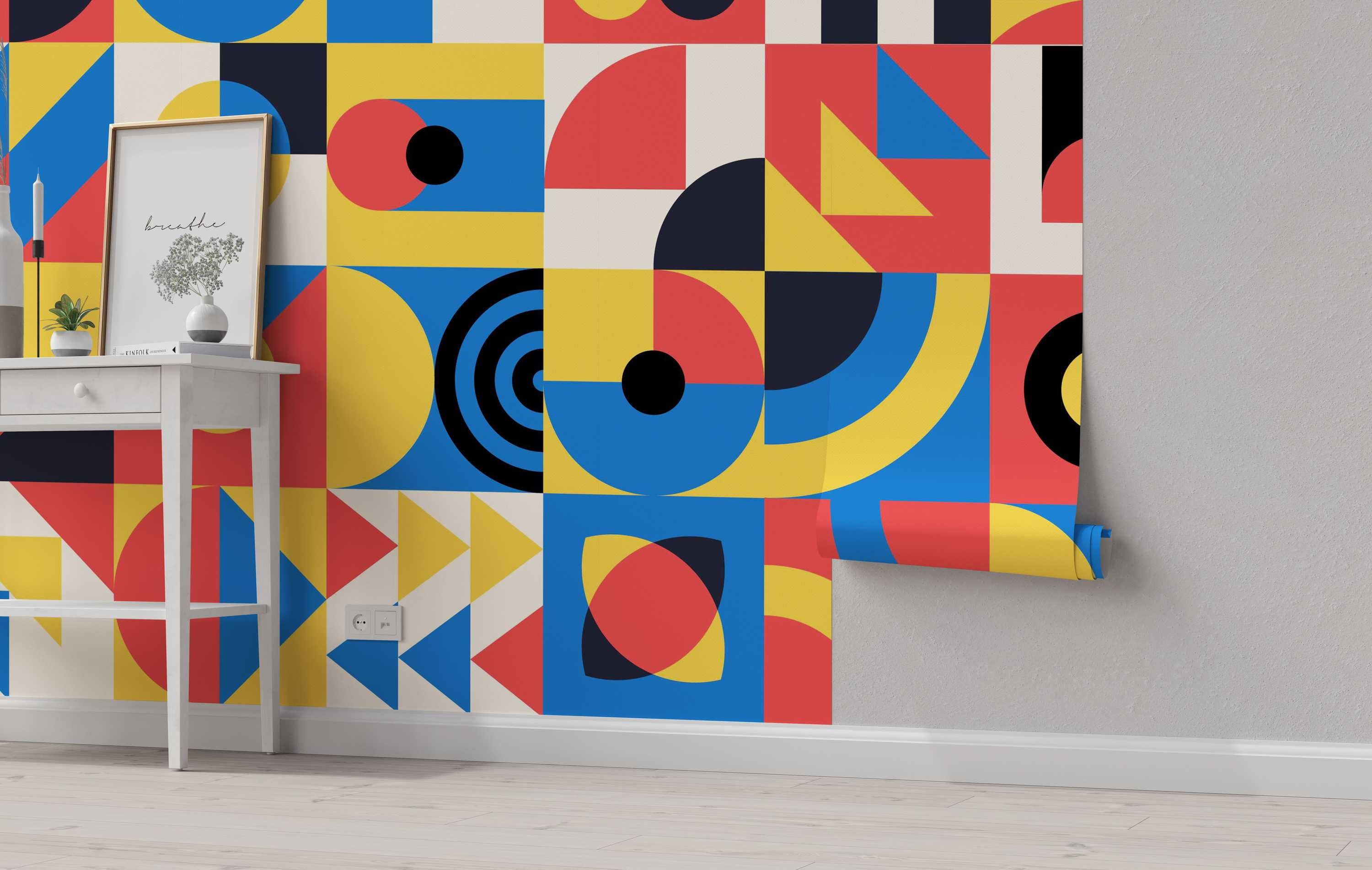 Bauhaus-inspired geometric wallpaper featuring a grid of blocks with circles, triangles, and arcs in primary blue, yellow, and red.