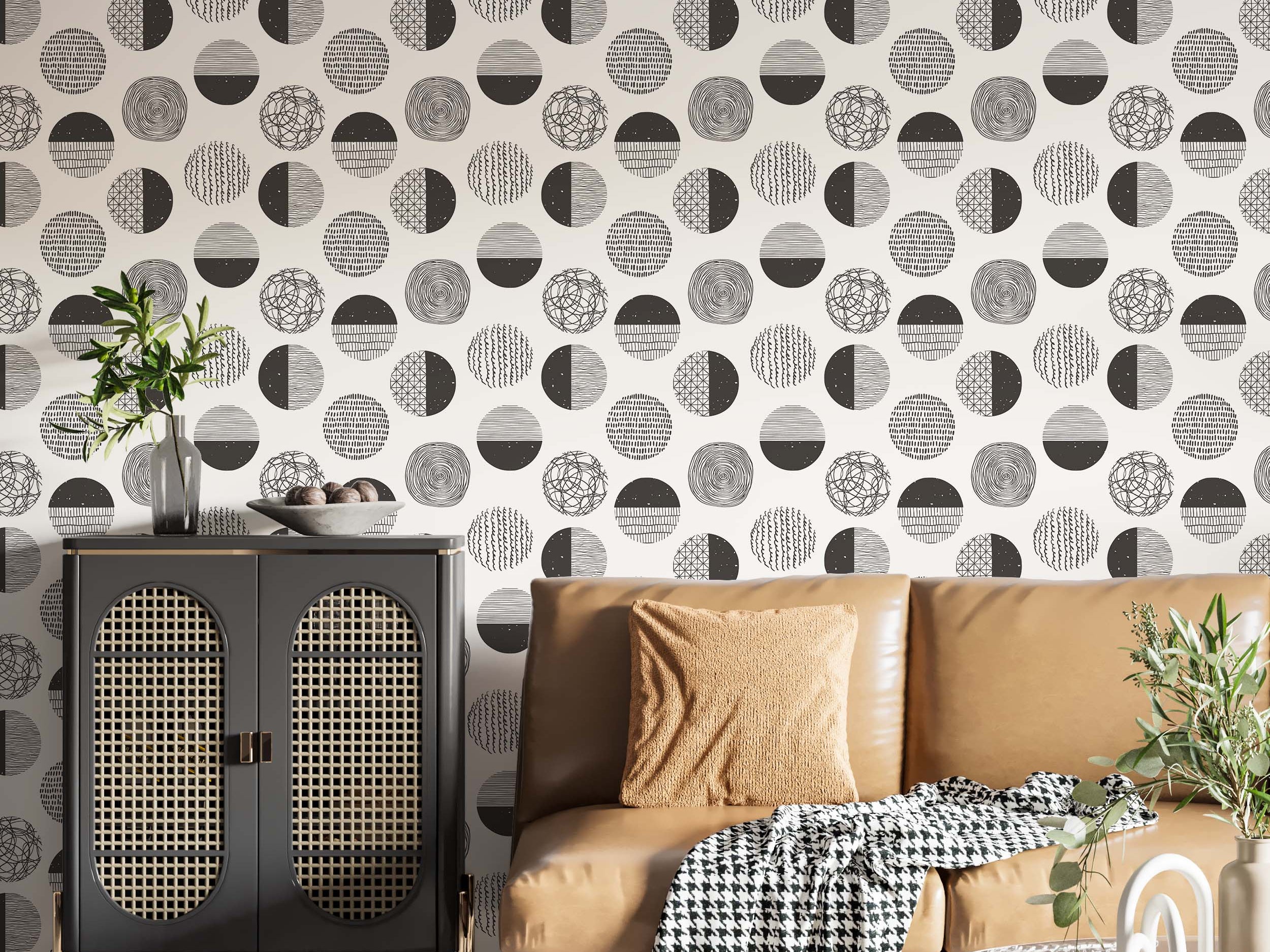 Wallpaper with a repeating pattern of circles featuring black hand-drawn abstract designs on an off-white background.