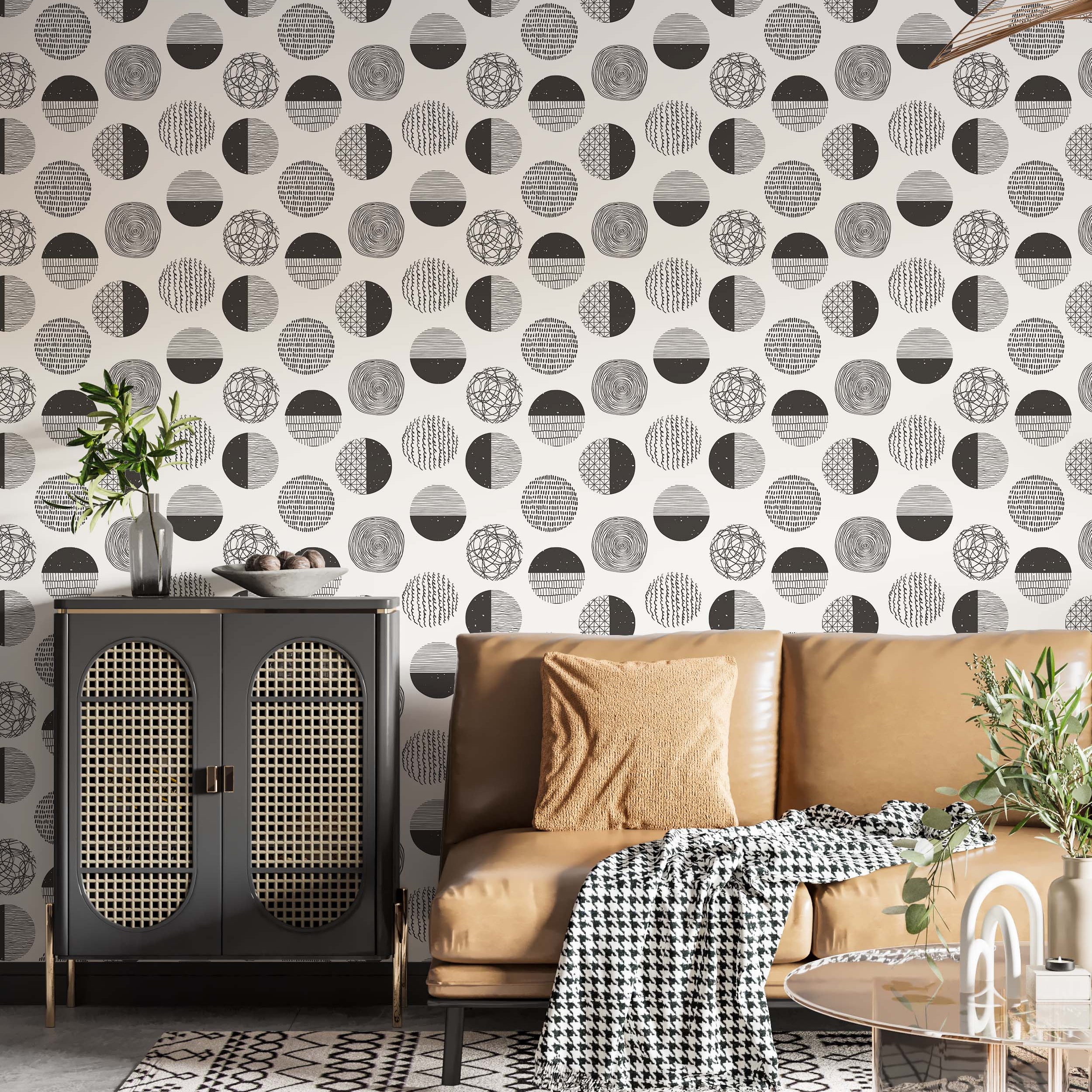 Wallpaper with a repeating pattern of circles featuring black hand-drawn abstract designs on an off-white background.