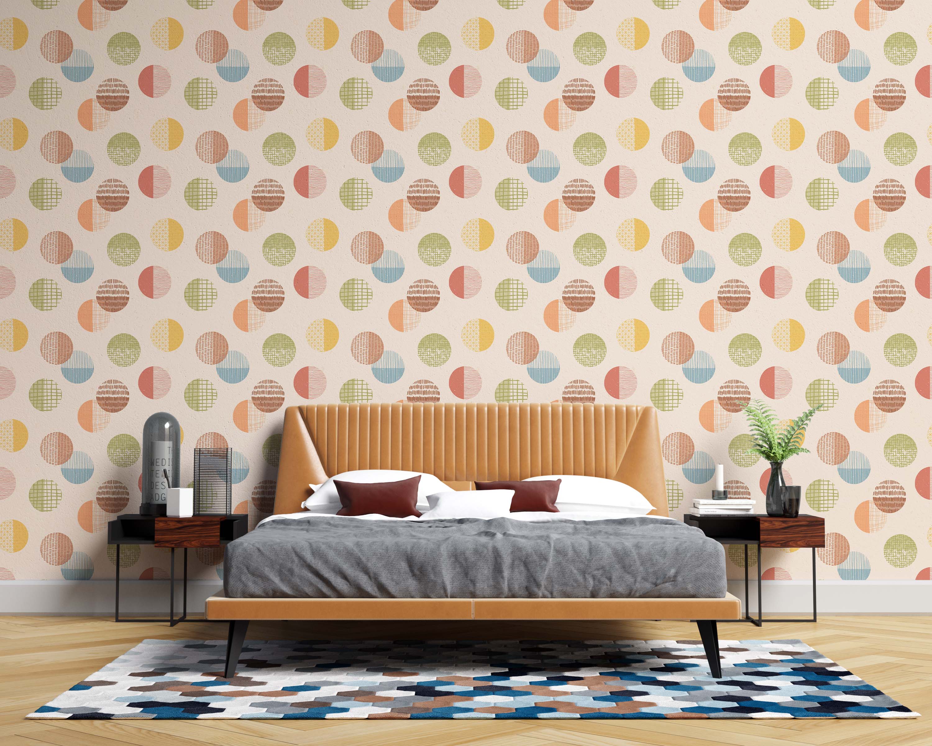 Wallpaper with a repeating pattern of textured circles in muted yellow, orange, blue, green, and brown on a light cream backdrop.