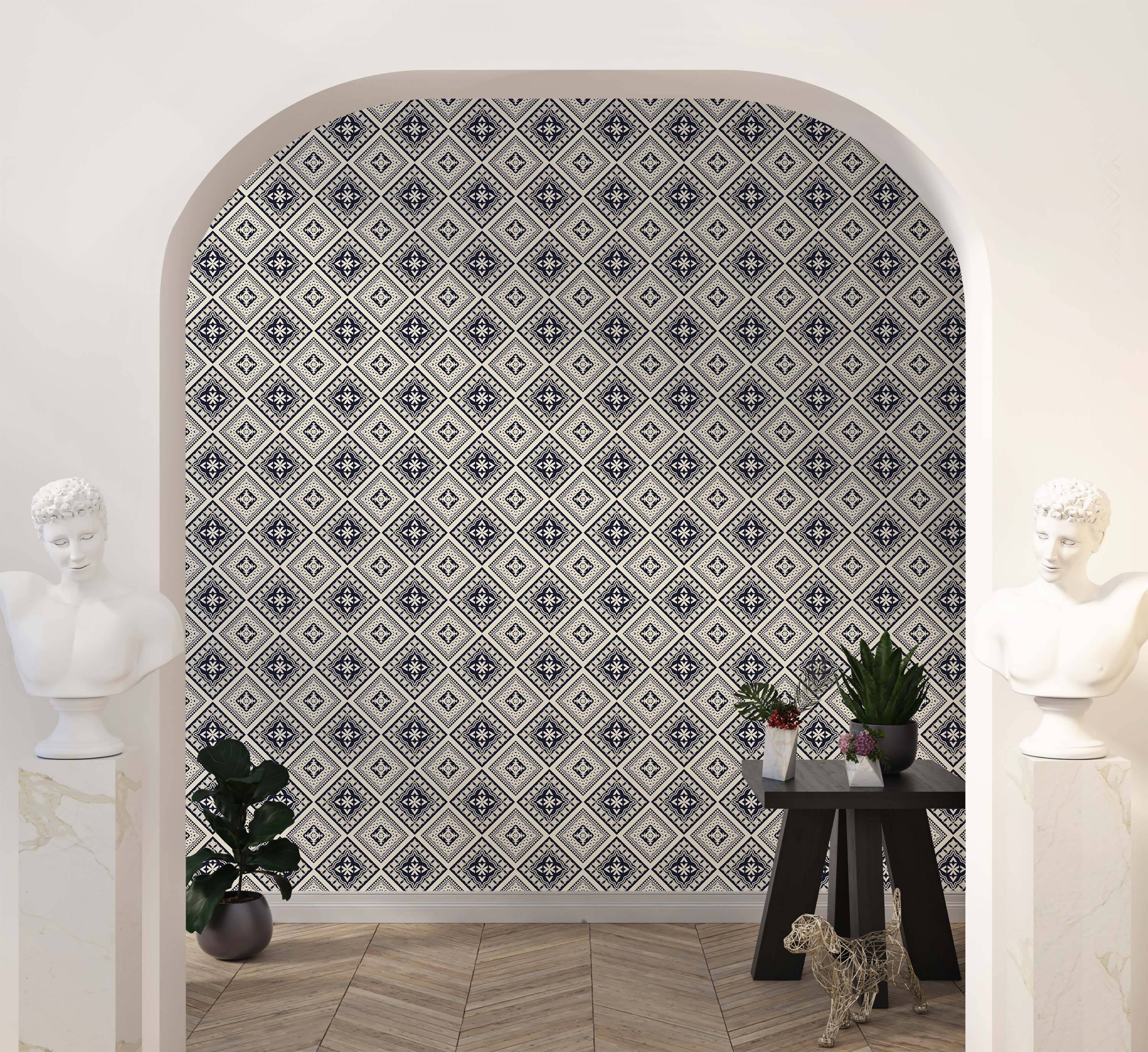 Geometric wallpaper with interlocking diamond tile patterns in dark blue and cream, featuring intricate central motifs.