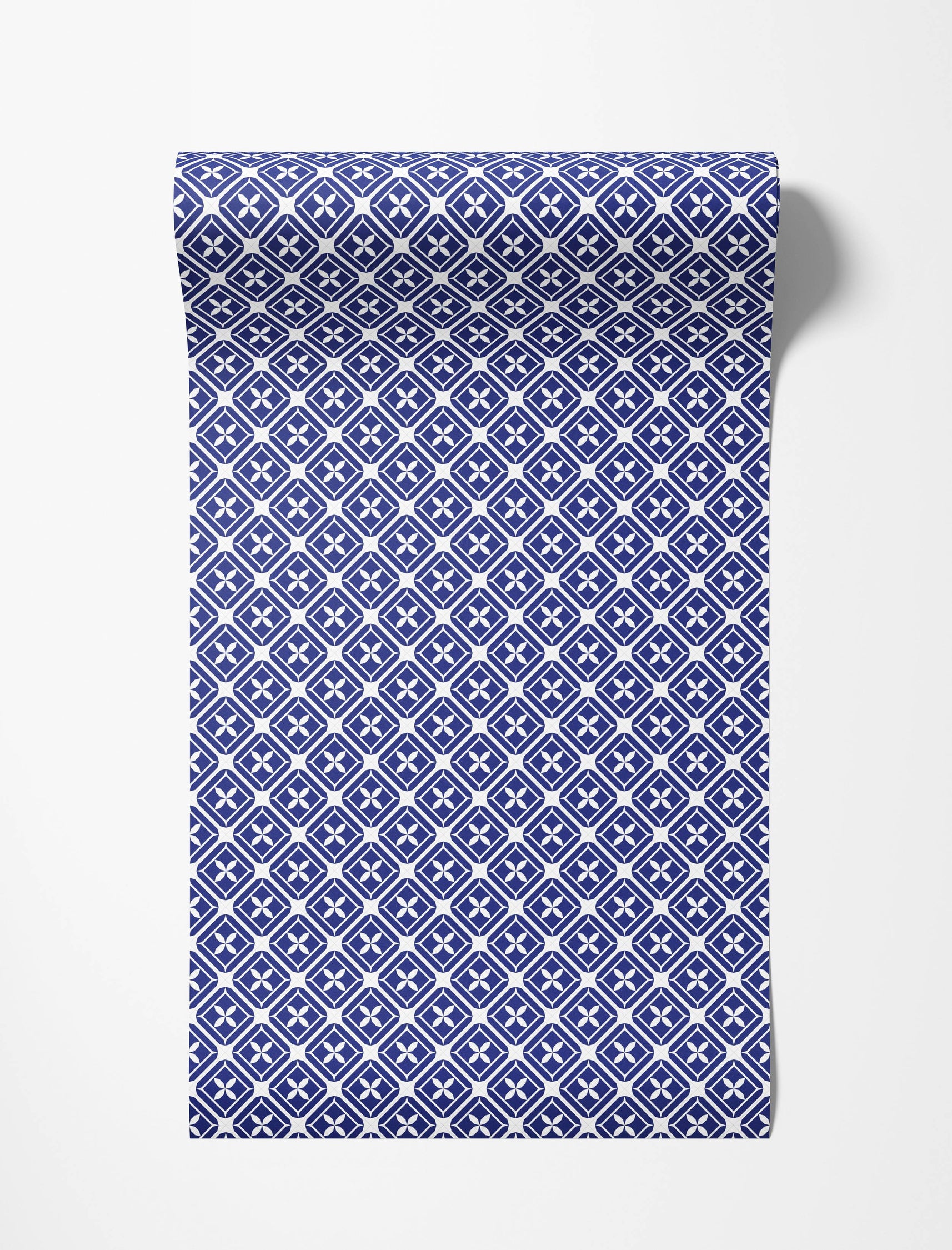 A geometric wallpaper in blue and white featuring a repeating diamond lattice pattern with four-petaled floral motifs.