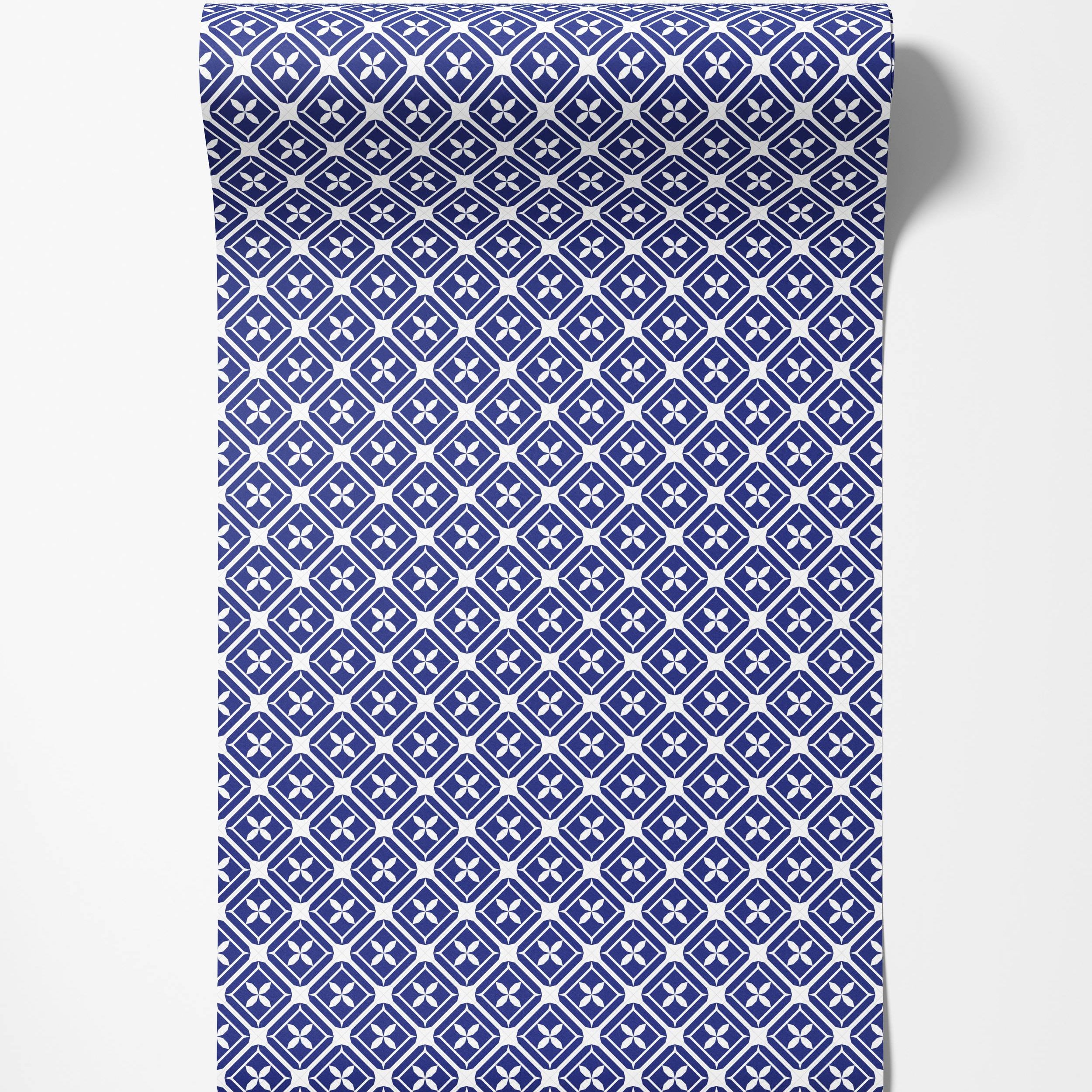 A geometric wallpaper in blue and white featuring a repeating diamond lattice pattern with four-petaled floral motifs.