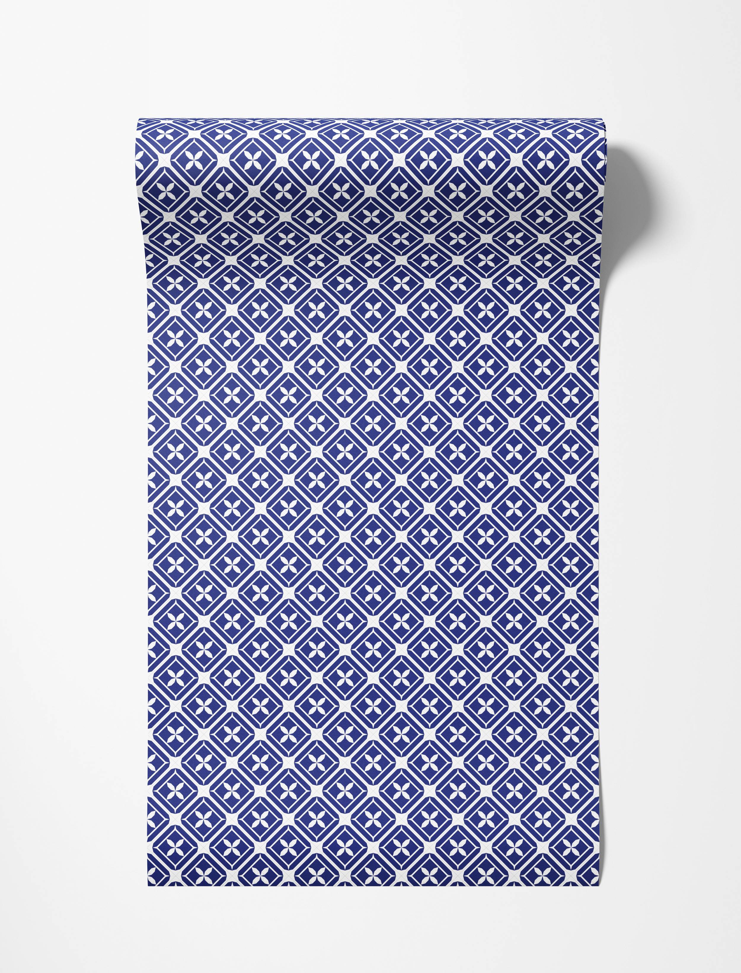 A geometric wallpaper in blue and white featuring a repeating diamond lattice pattern with four-petaled floral motifs.