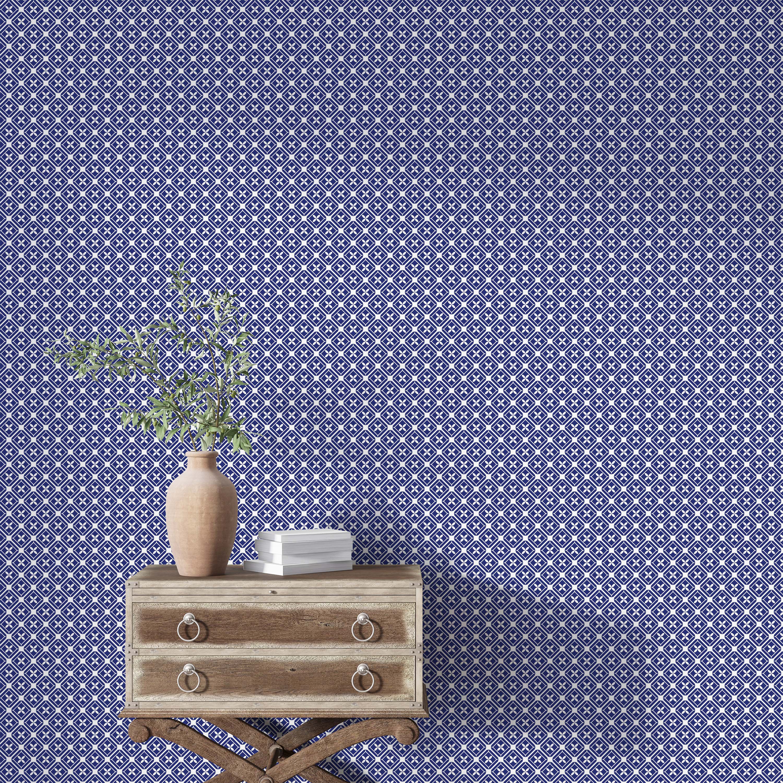 Wallpaper with an intricate geometric tile pattern of blue and white diamonds, each with a central four-leaf motif.