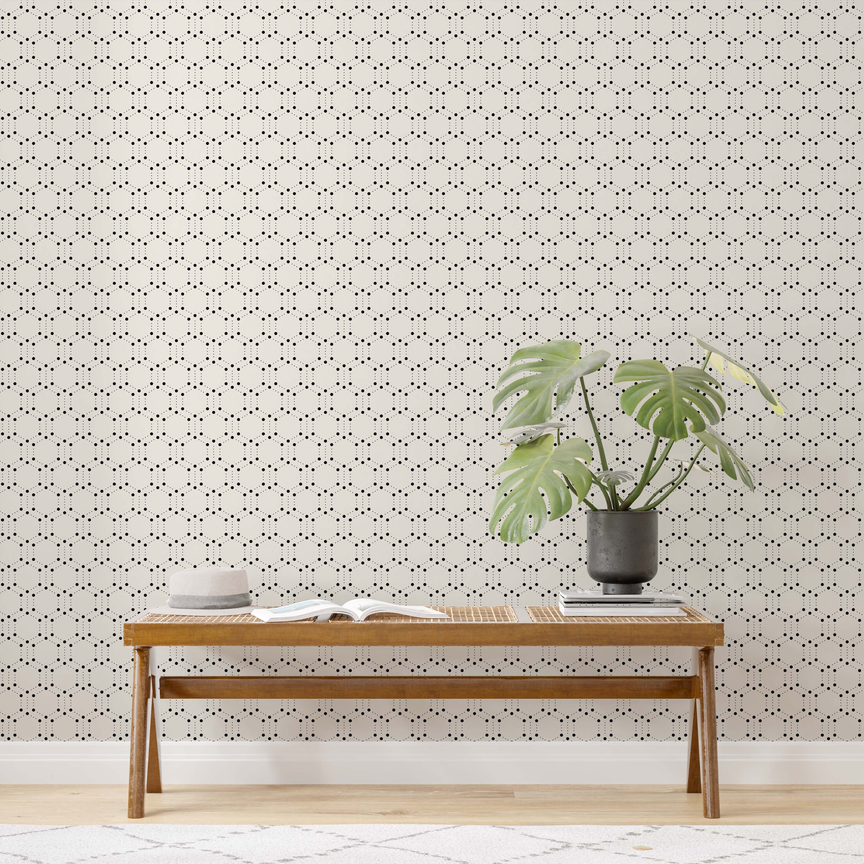 Geometric wallpaper featuring repeating hexagons formed by black dots on a light cream background.