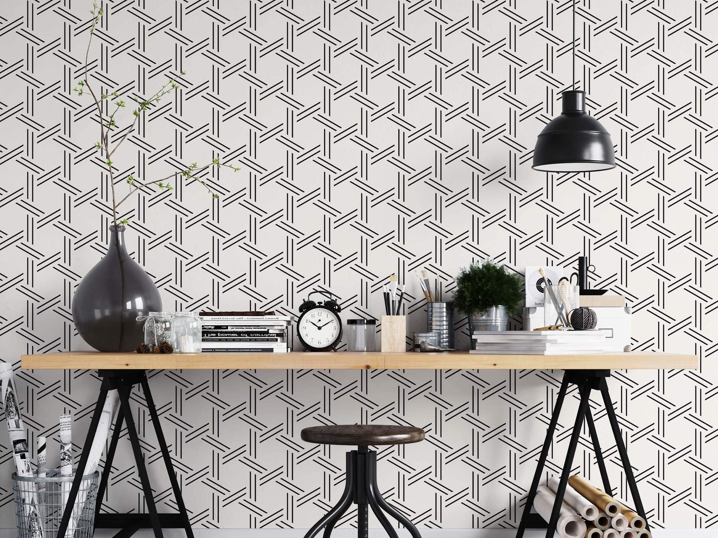 Geometric wallpaper featuring intersecting black parallel lines forming a woven lattice pattern on a white background.