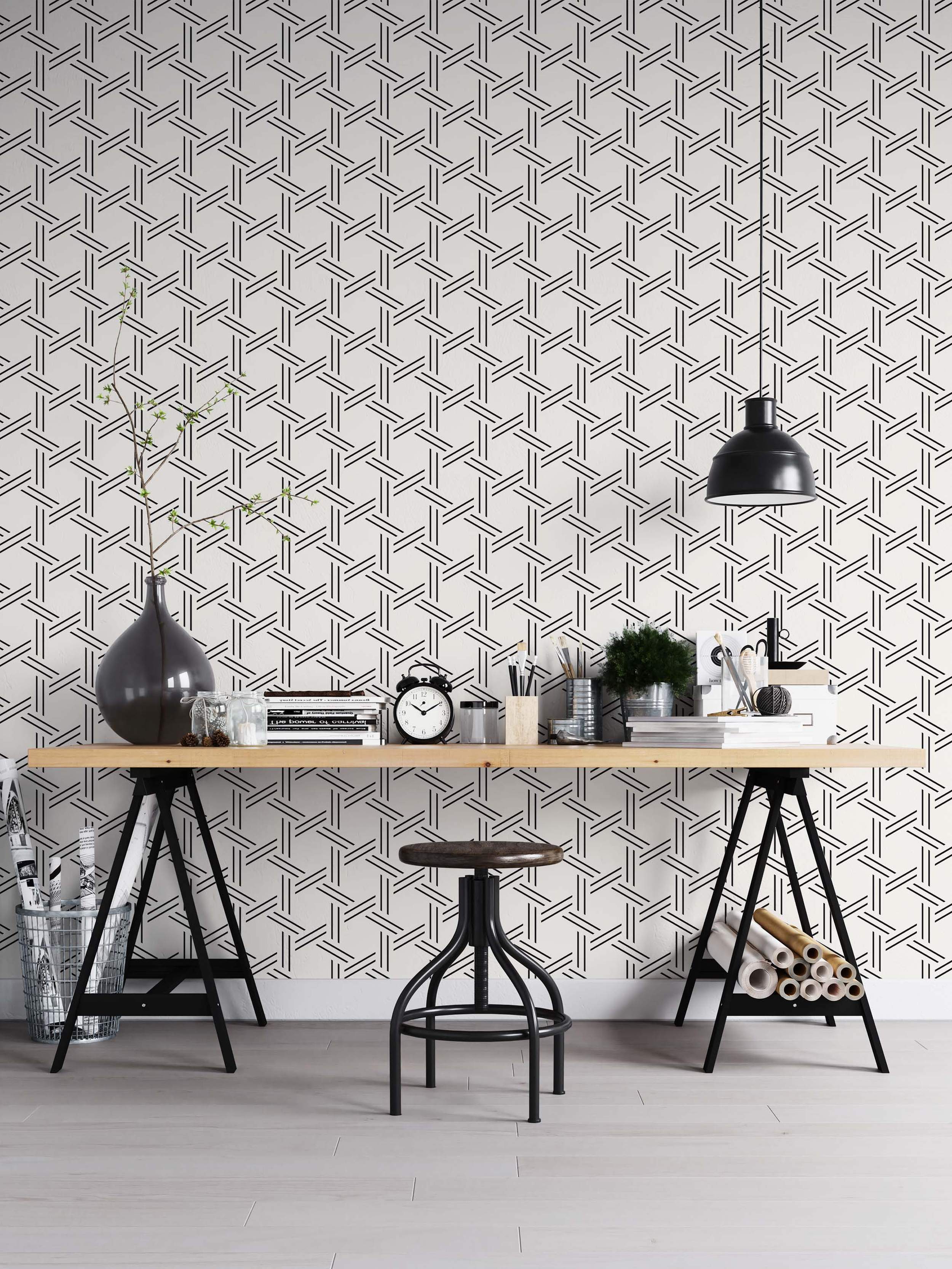 Geometric wallpaper featuring intersecting black parallel lines forming a woven lattice pattern on a white background.