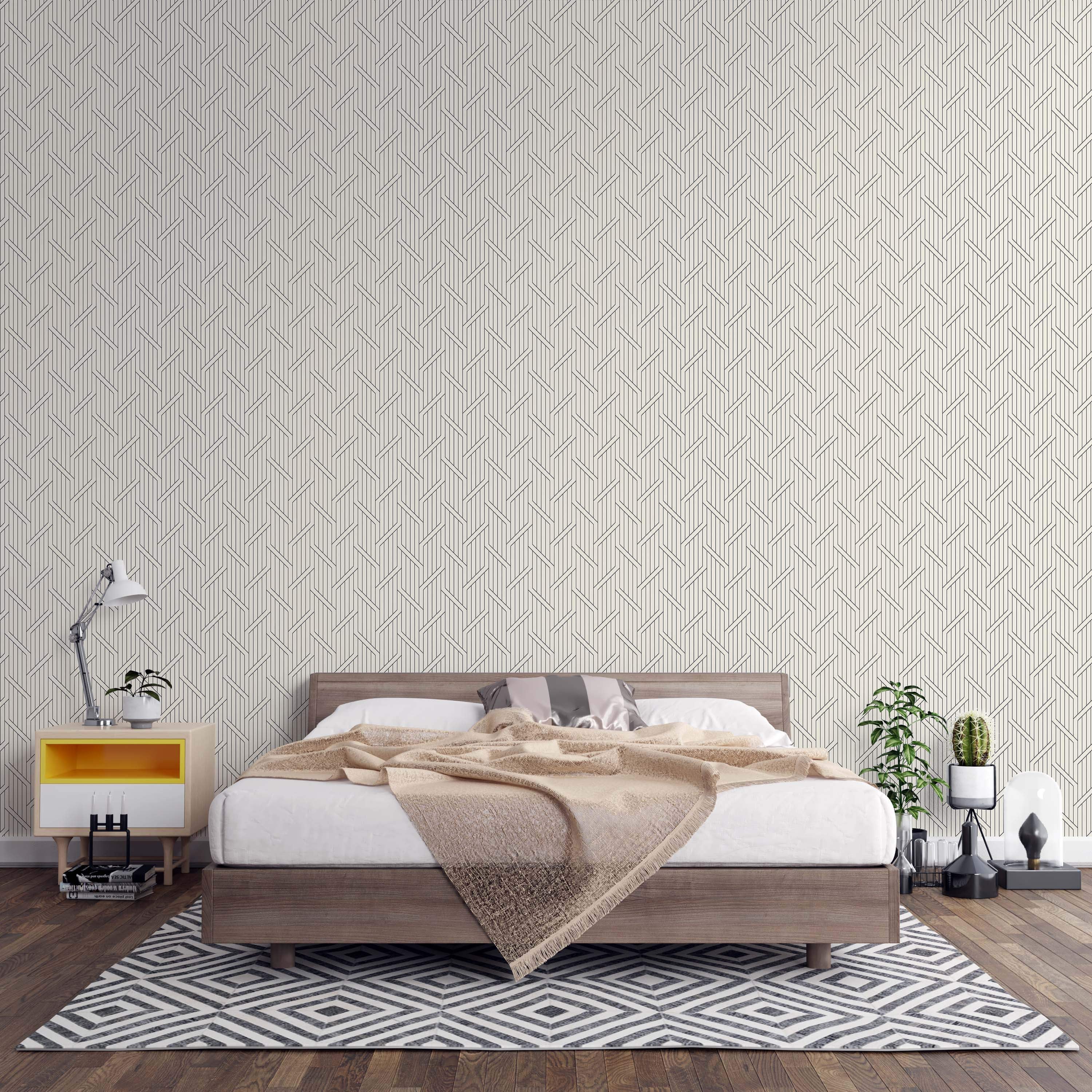 Beige wallpaper with a geometric pattern of intersecting thin black vertical and diagonal lines.