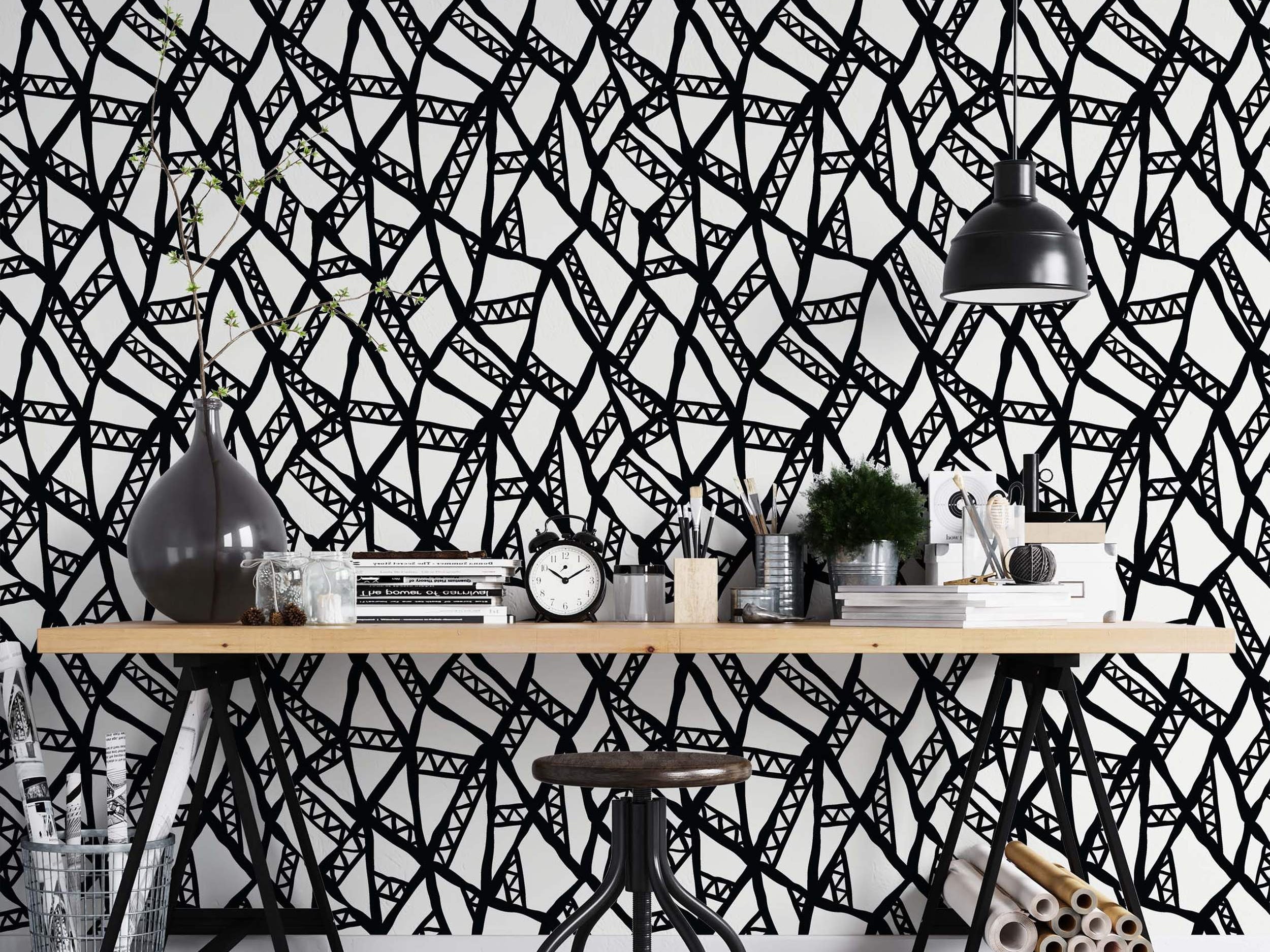 Abstract wallpaper with a hand-drawn black geometric line network featuring internal triangle patterns on a white background.