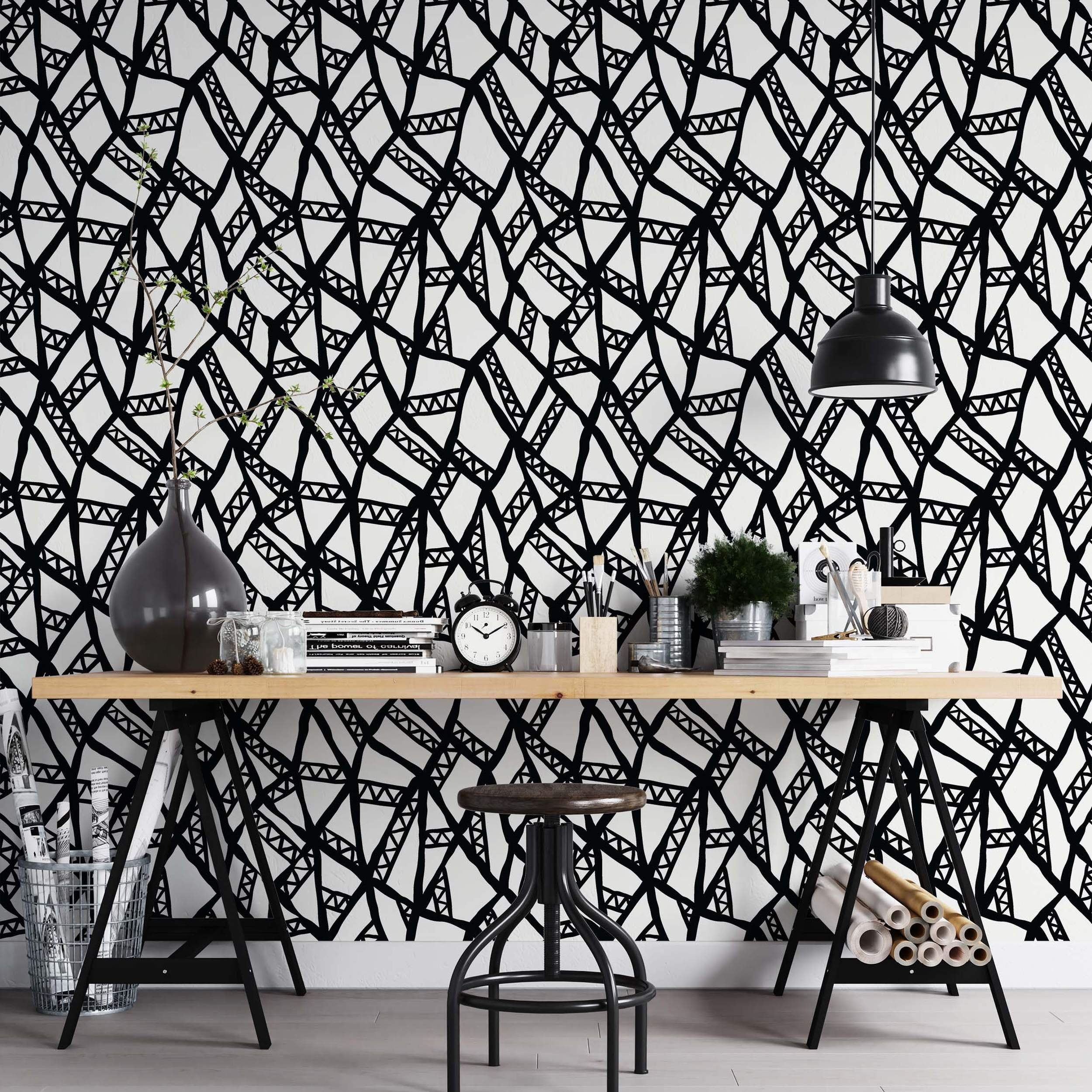 Abstract wallpaper with a hand-drawn black geometric line network featuring internal triangle patterns on a white background.