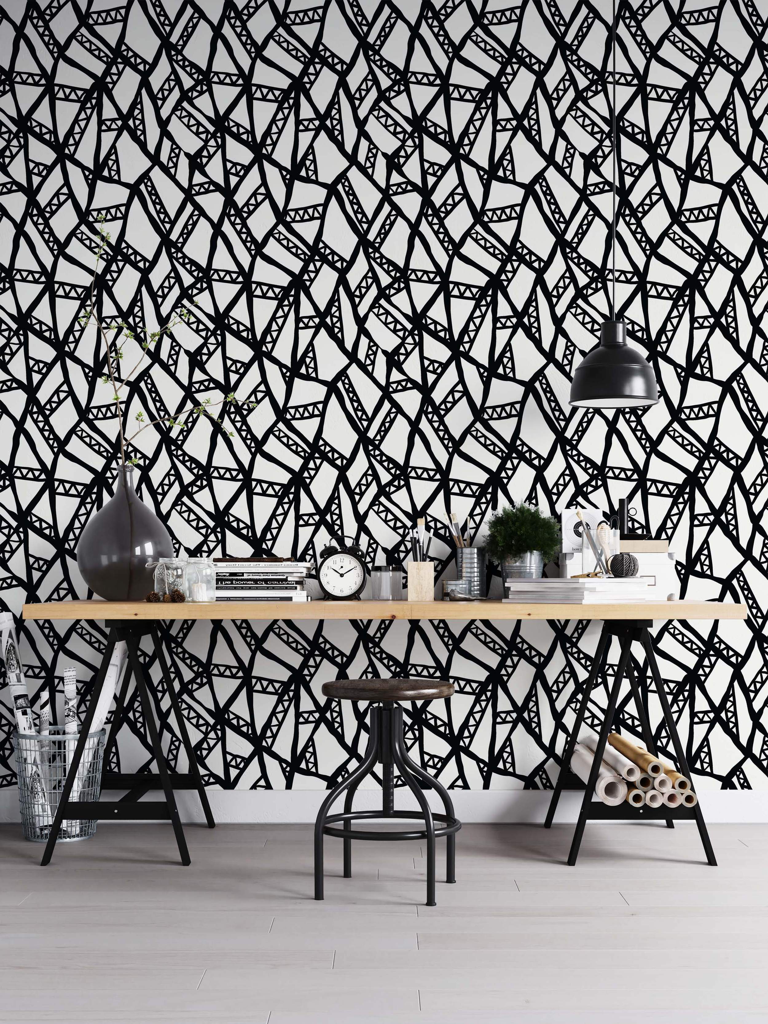 Abstract wallpaper with a hand-drawn black geometric line network featuring internal triangle patterns on a white background.