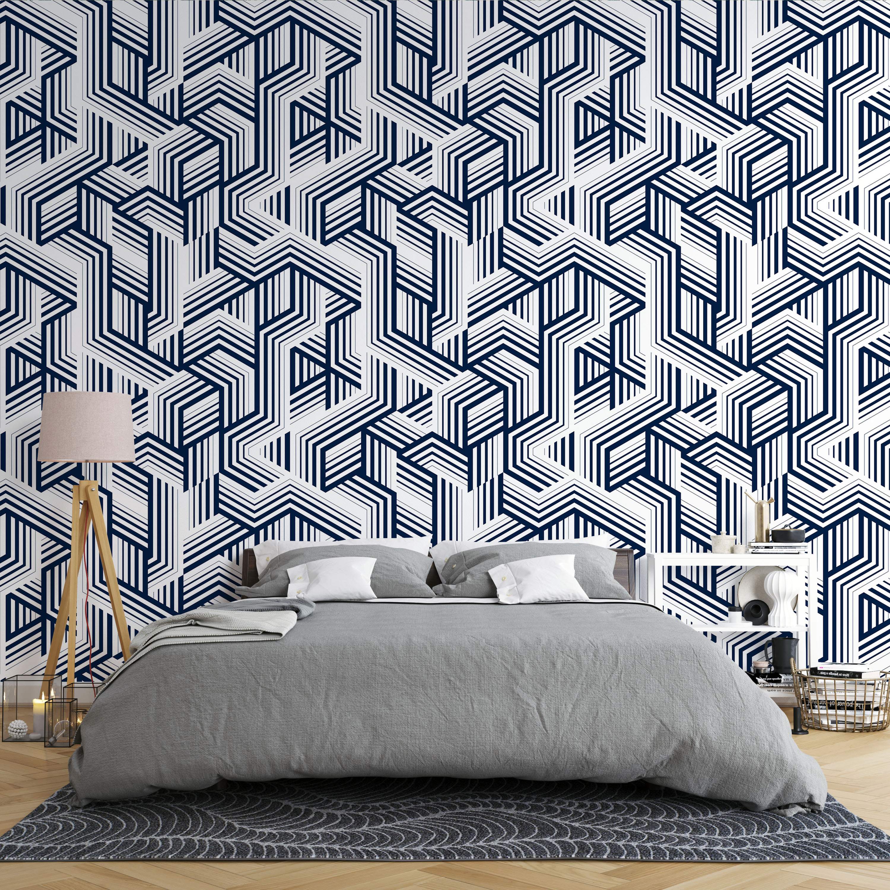 Geometric wallpaper with complex, interlocking angular line patterns in navy blue and white.