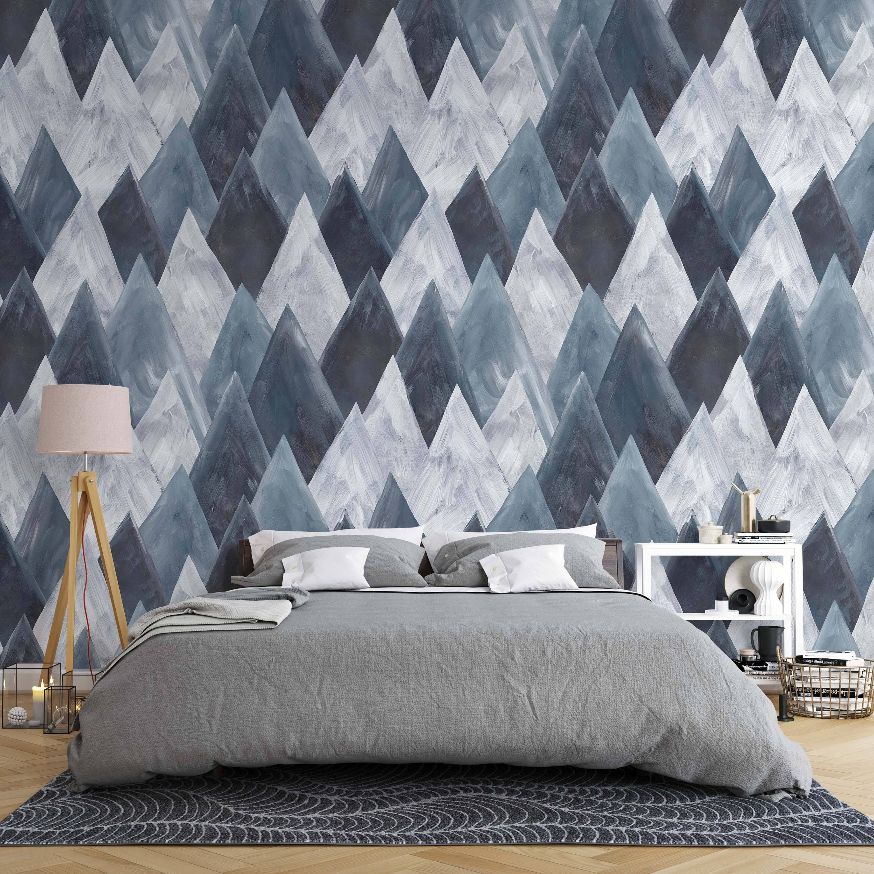 Abstract mountain peak wallpaper with a painterly texture in various shades of blue-gray and white.