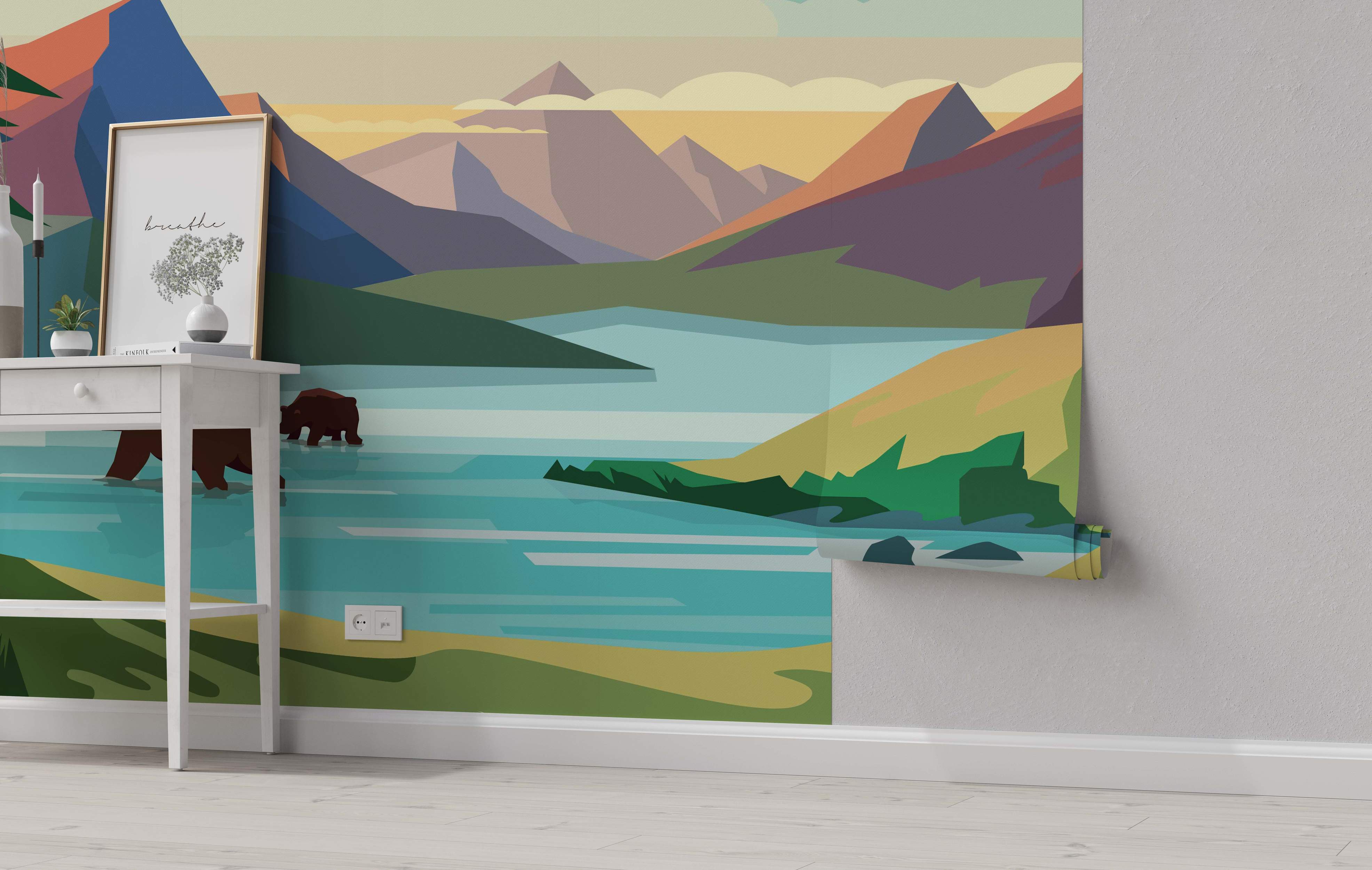 Geometric landscape mural featuring stylized mountains in purple, orange, and blue overlooking a turquoise lake with green shores.
