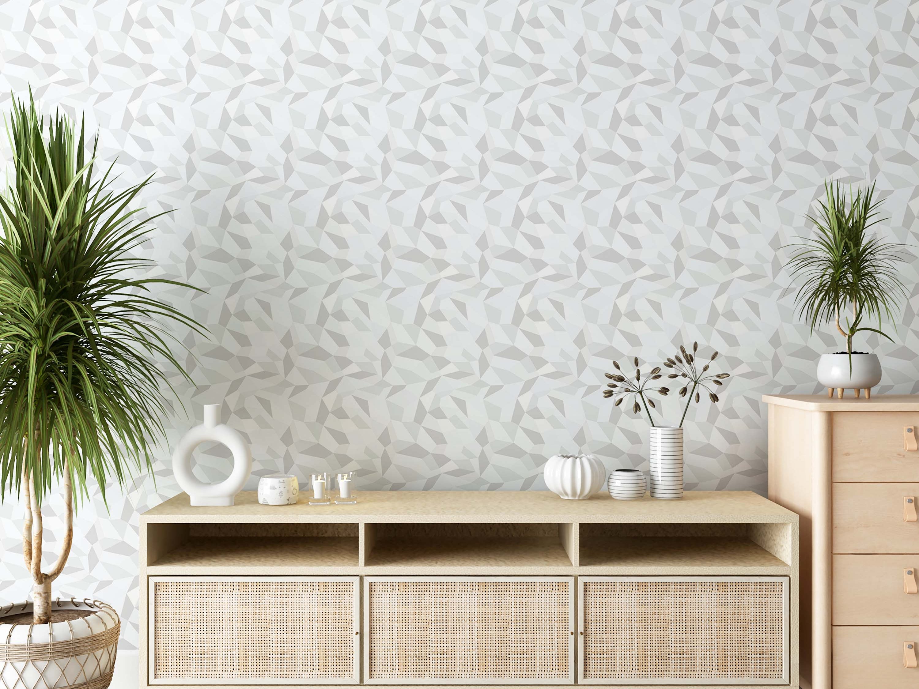 Geometric wallpaper with a pattern of irregular polygons in shades of light gray and white.