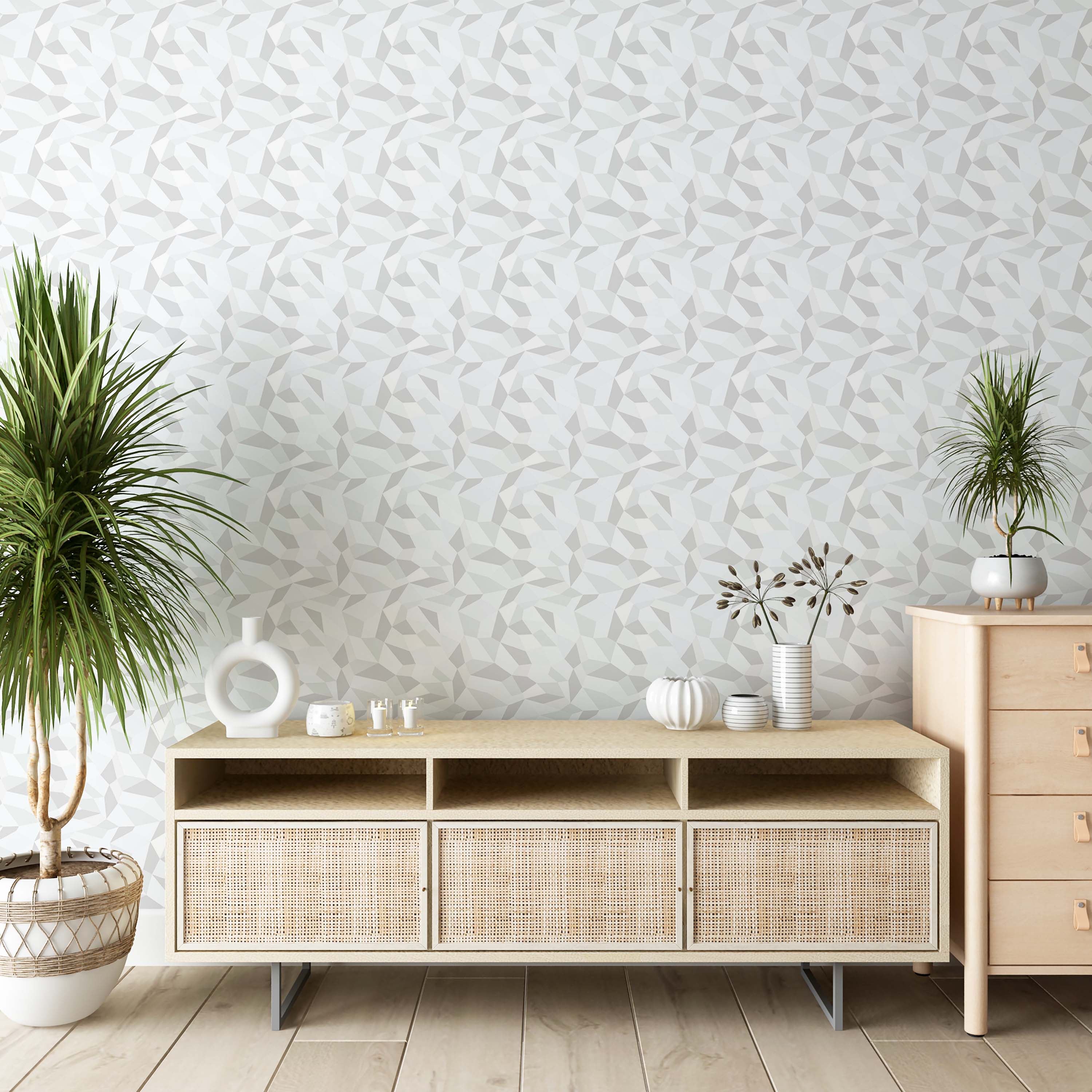Geometric wallpaper with a pattern of irregular polygons in shades of light gray and white.
