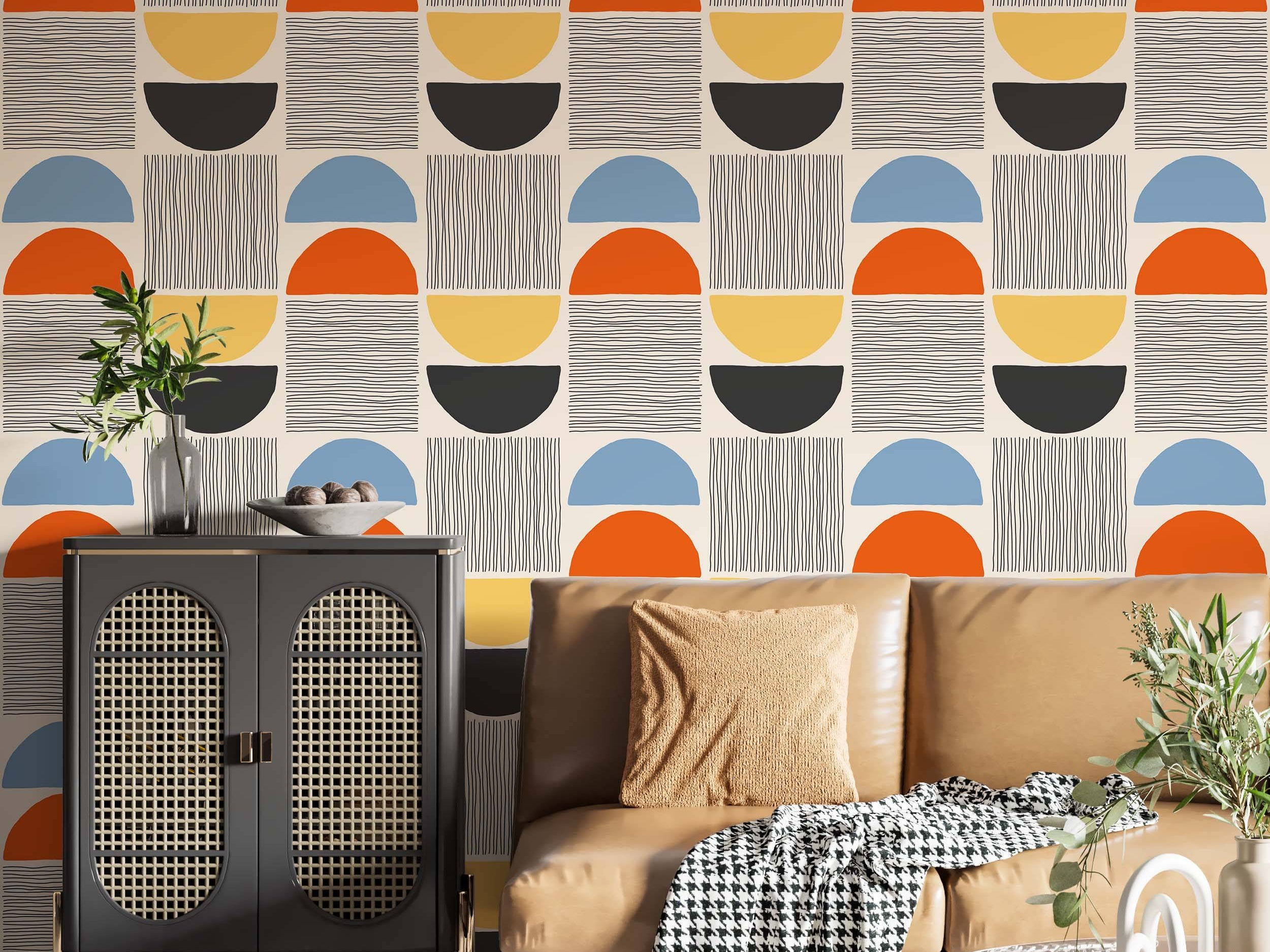 Geometric wallpaper with stacked semi-circles in blue, orange, yellow, black, and coordinating line patterns on a beige background.