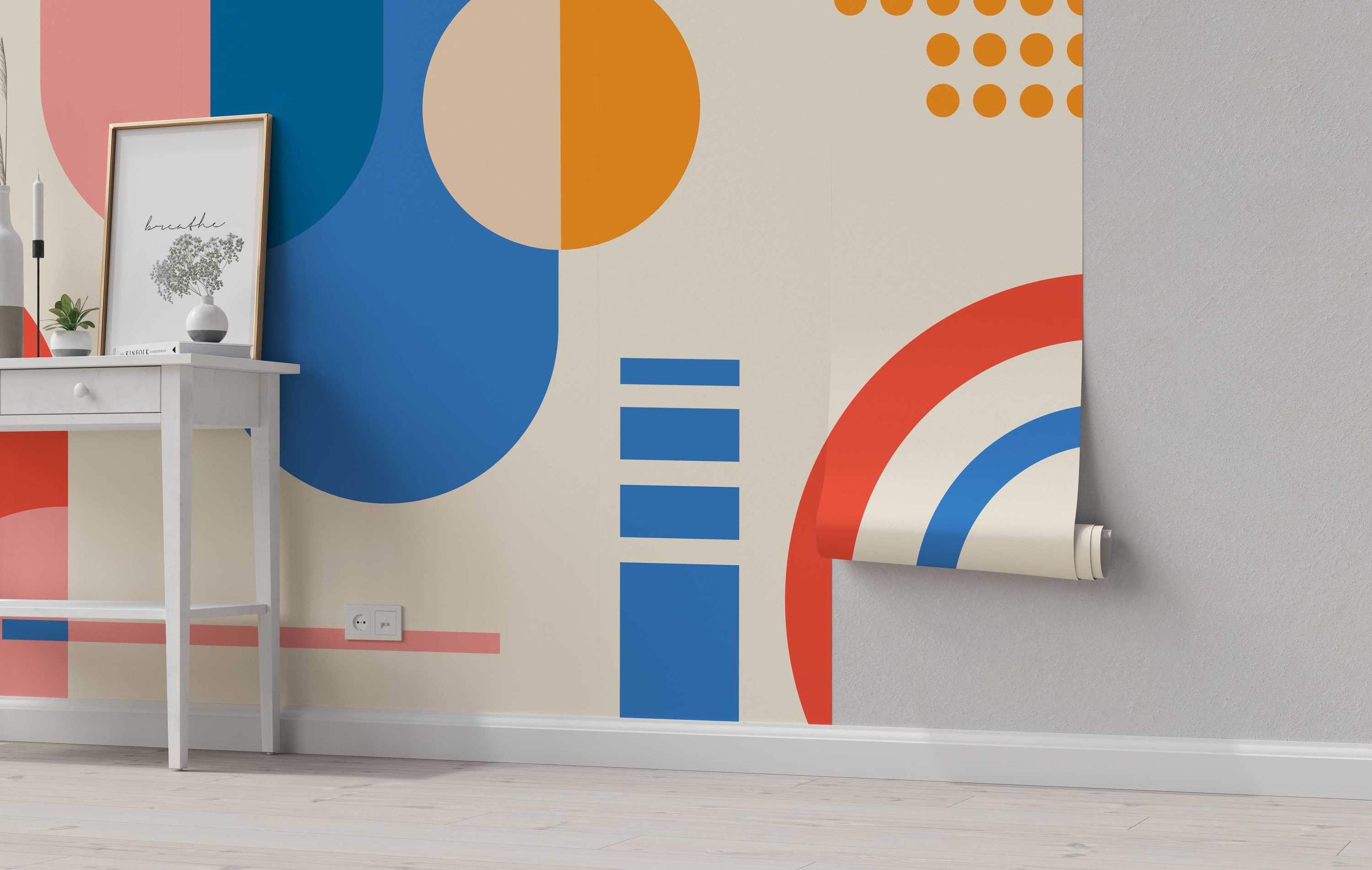 Abstract geometric mural featuring large blue, orange, and pink circles, rectangles, and arcs on a beige background.