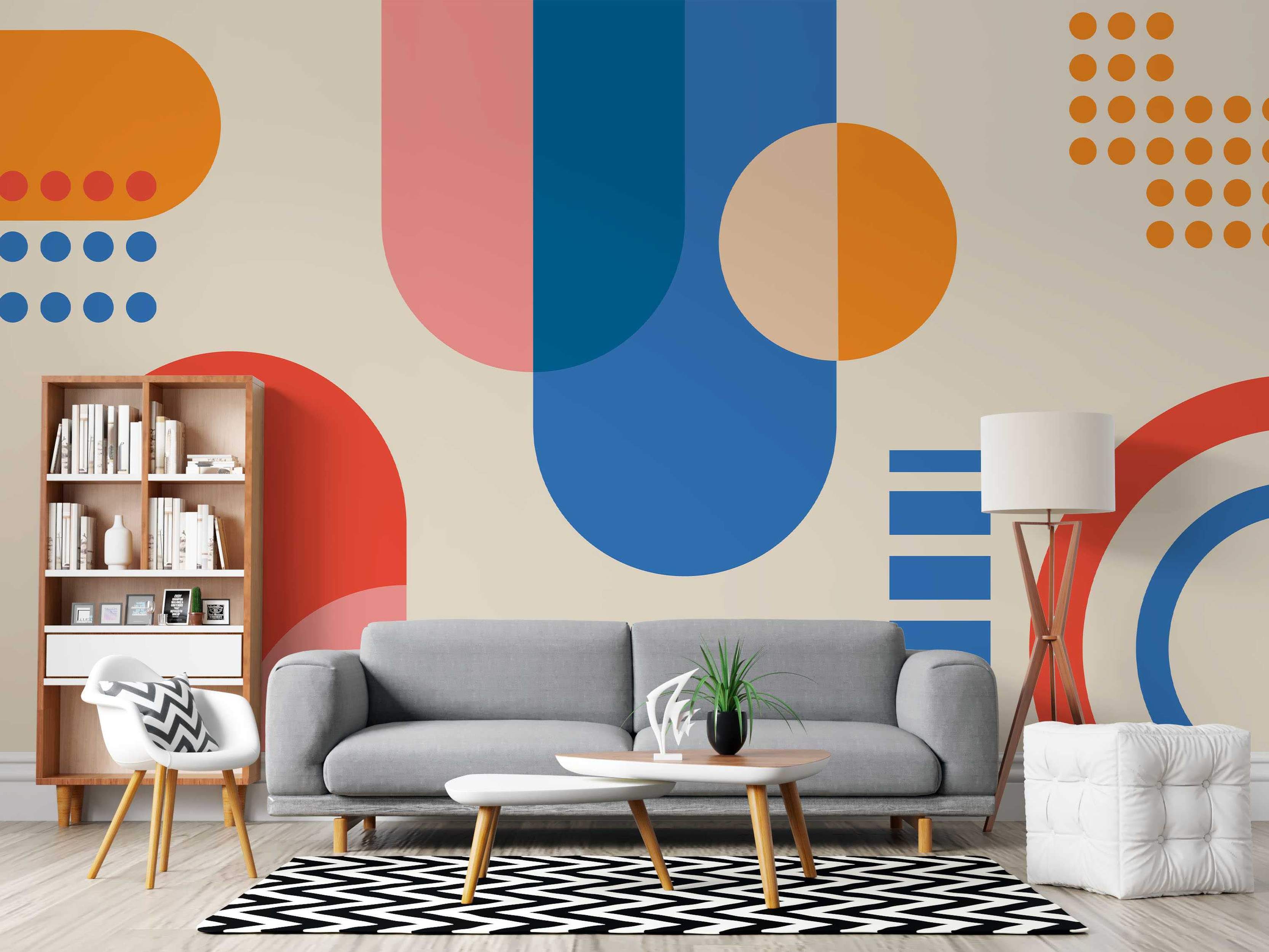 Abstract geometric mural featuring large circles, semi-circles, and dots in blue, orange, pink, and red on a beige backdrop.