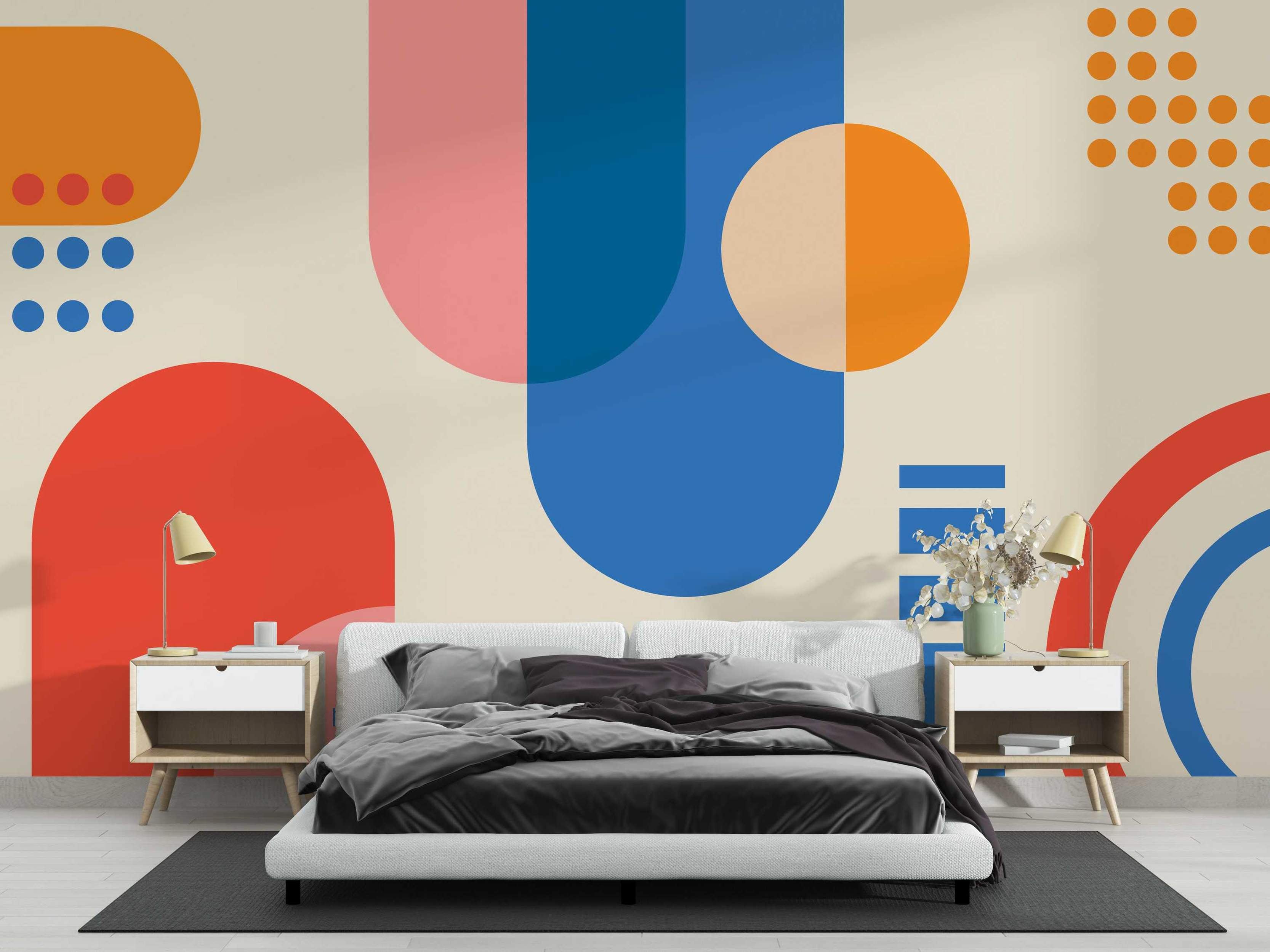 Abstract geometric mural featuring large orange, blue, red, and pink circles, arcs, and dots on a beige background.