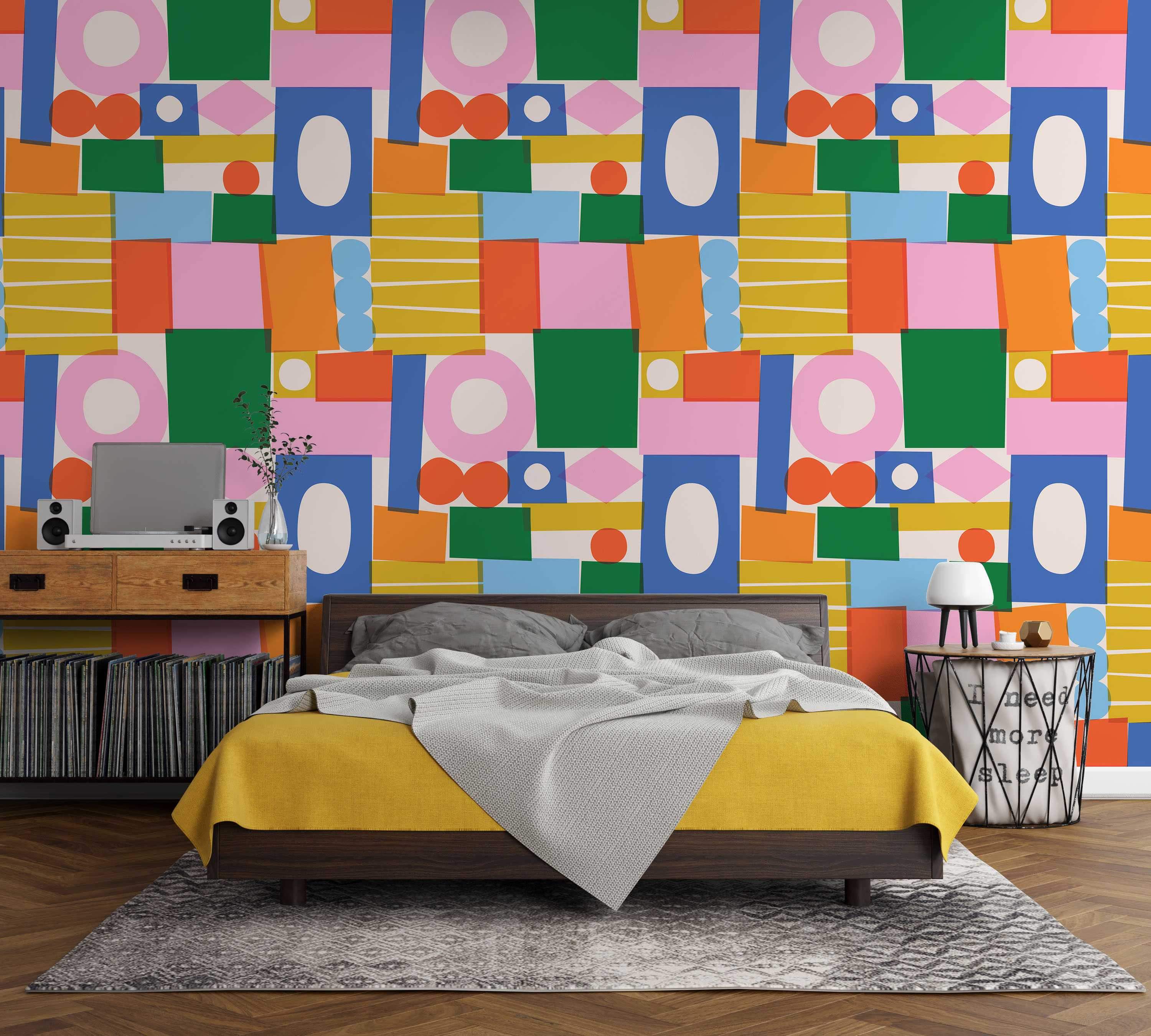 Abstract wallpaper featuring overlapping geometric shapes in blue, green, pink, orange, and yellow on a light background.