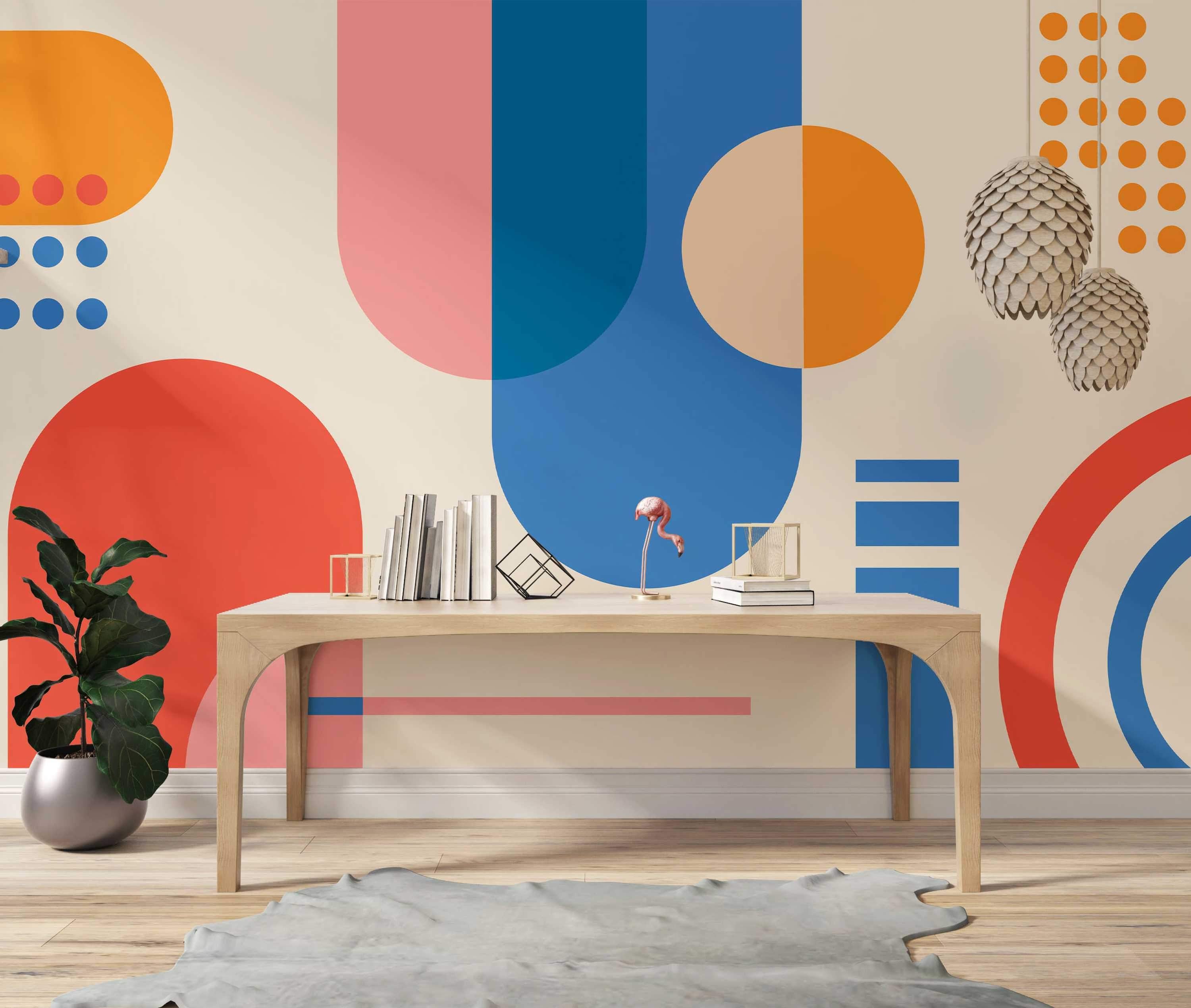 Geometric mural featuring large, overlapping circles, semi-circles, and rectangles in orange, red, blue, and pink on beige.