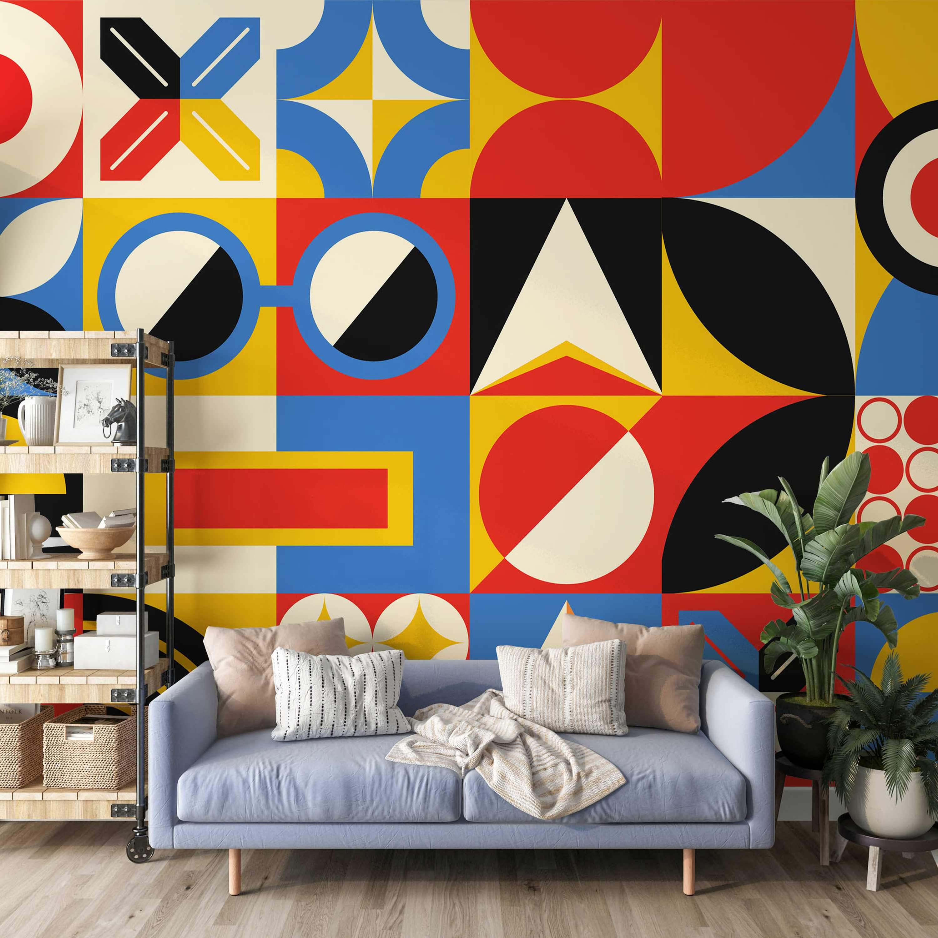 Bold geometric mural with block patterns in red, blue, yellow, black, and cream, featuring circles, triangles, and quarter circles.