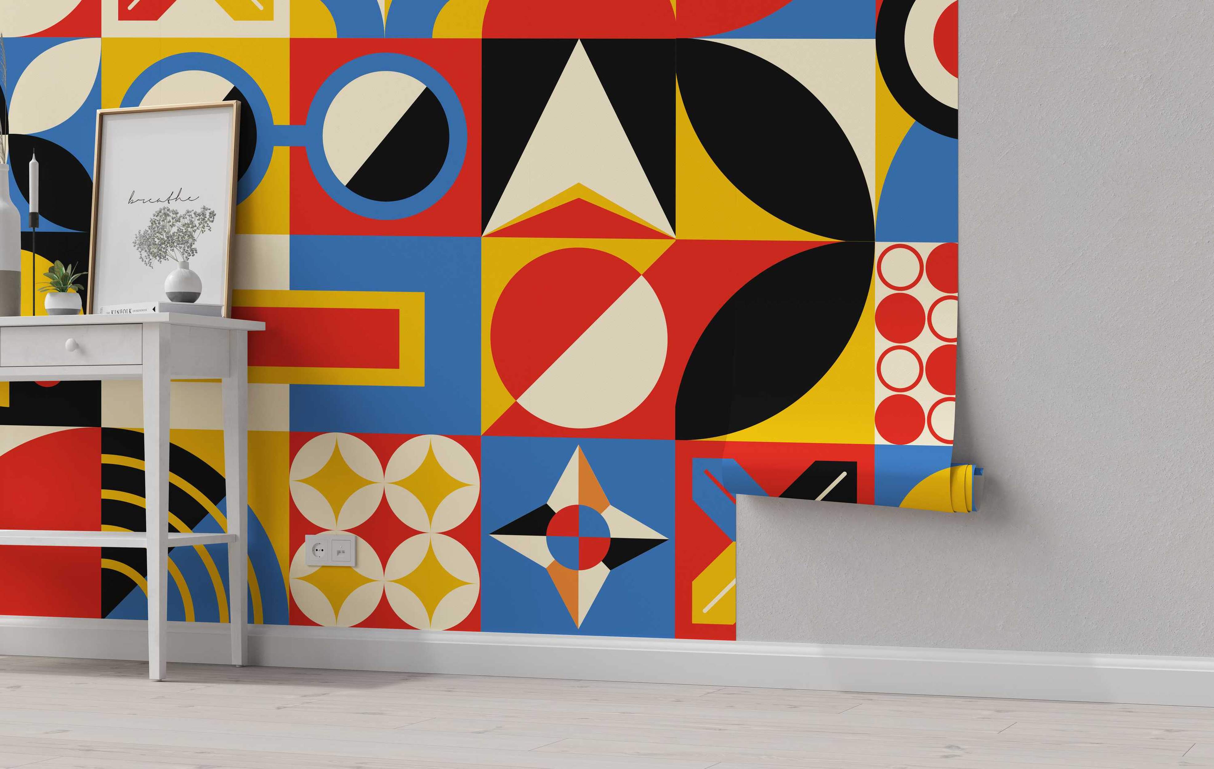Geometric wallpaper with a grid pattern featuring circles, triangles, and abstract shapes in bold red, blue, yellow, black, and cream.