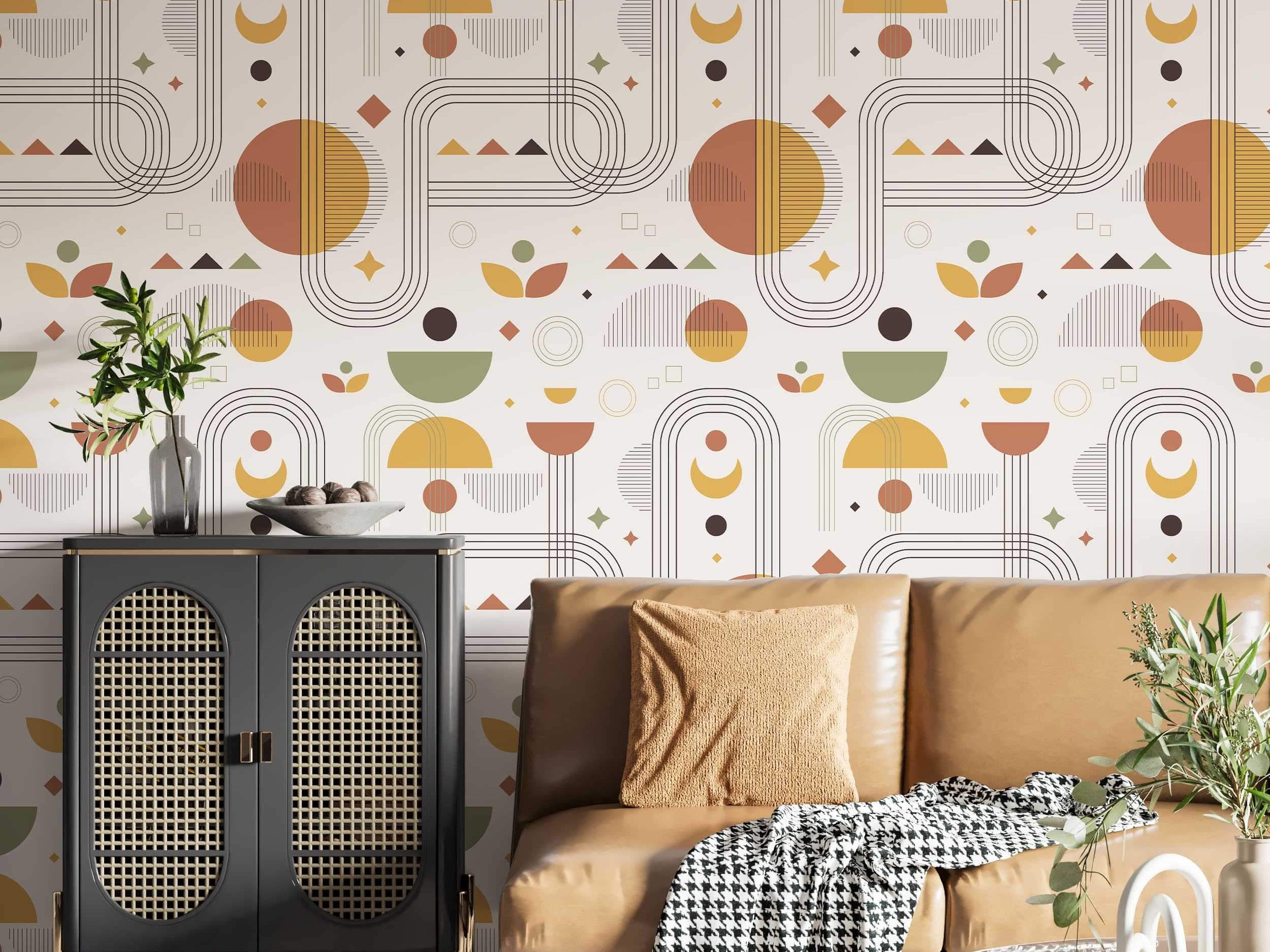 Repeating wallpaper pattern of geometric shapes like arches, semi-circles, and lines in earthy rust, yellow, and green tones.