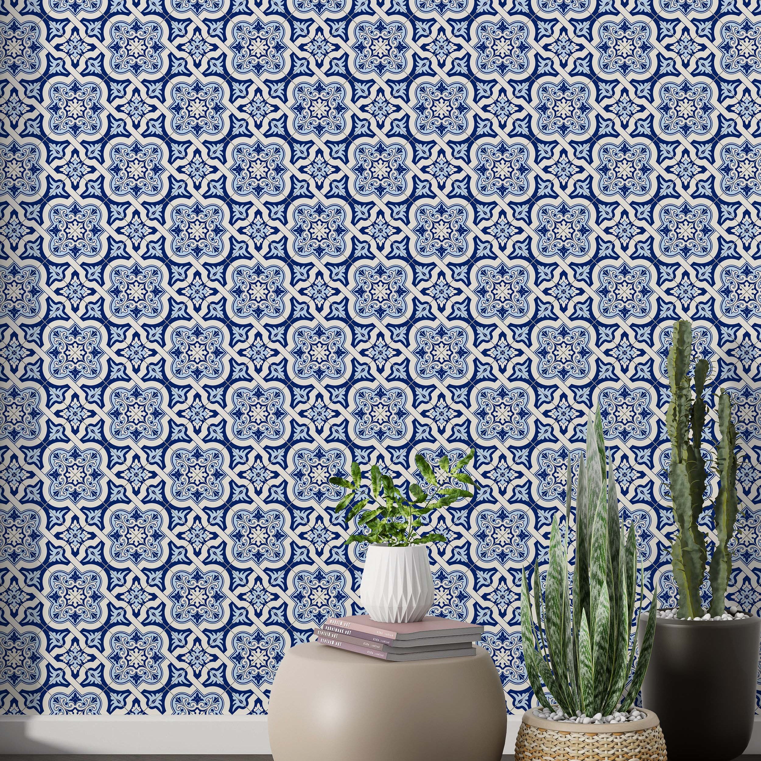 Geometric tile wallpaper with repeating blue and off-white quatrefoil motifs, detailed with intricate floral elements.