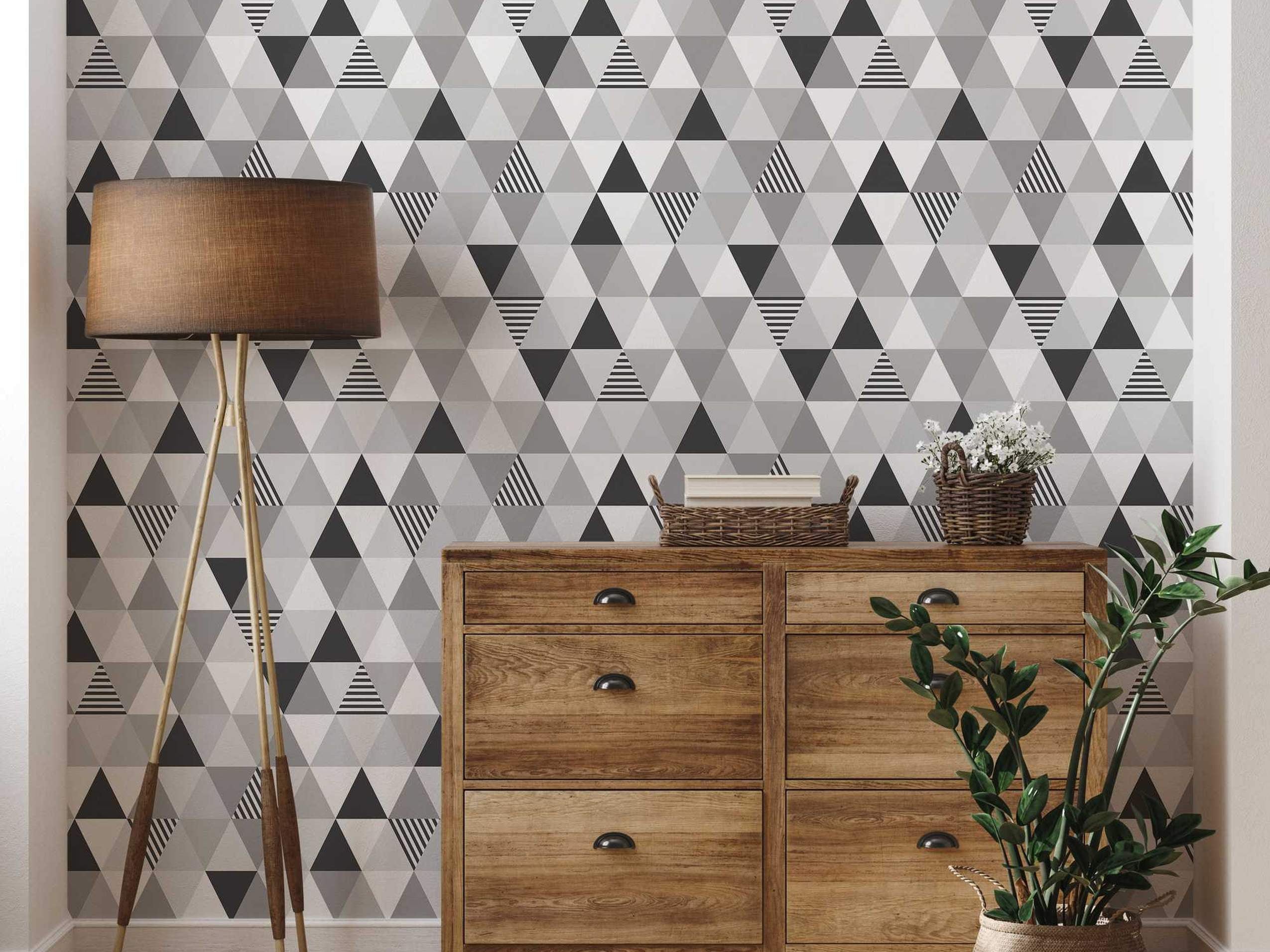 Geometric wallpaper featuring triangles in solid black, white, shades of gray, and black-and-white stripes.