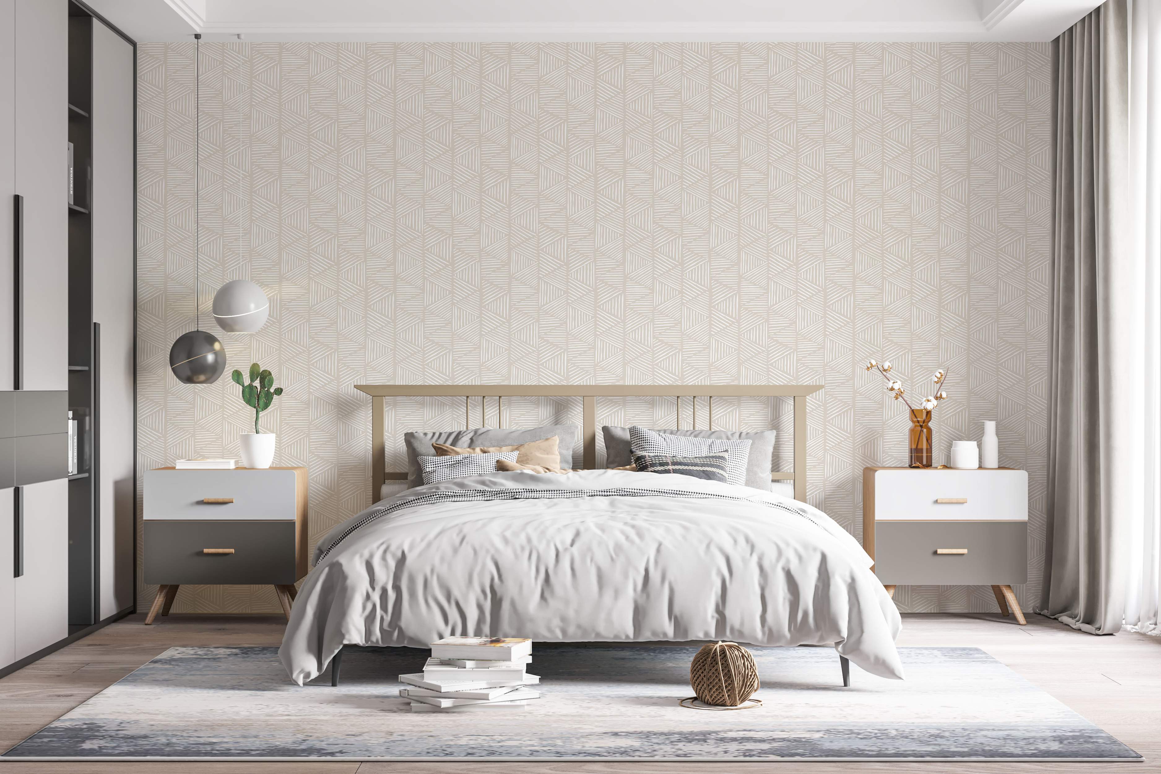 Geometric wallpaper featuring triangles filled with sketched white diagonal lines on a light beige background.