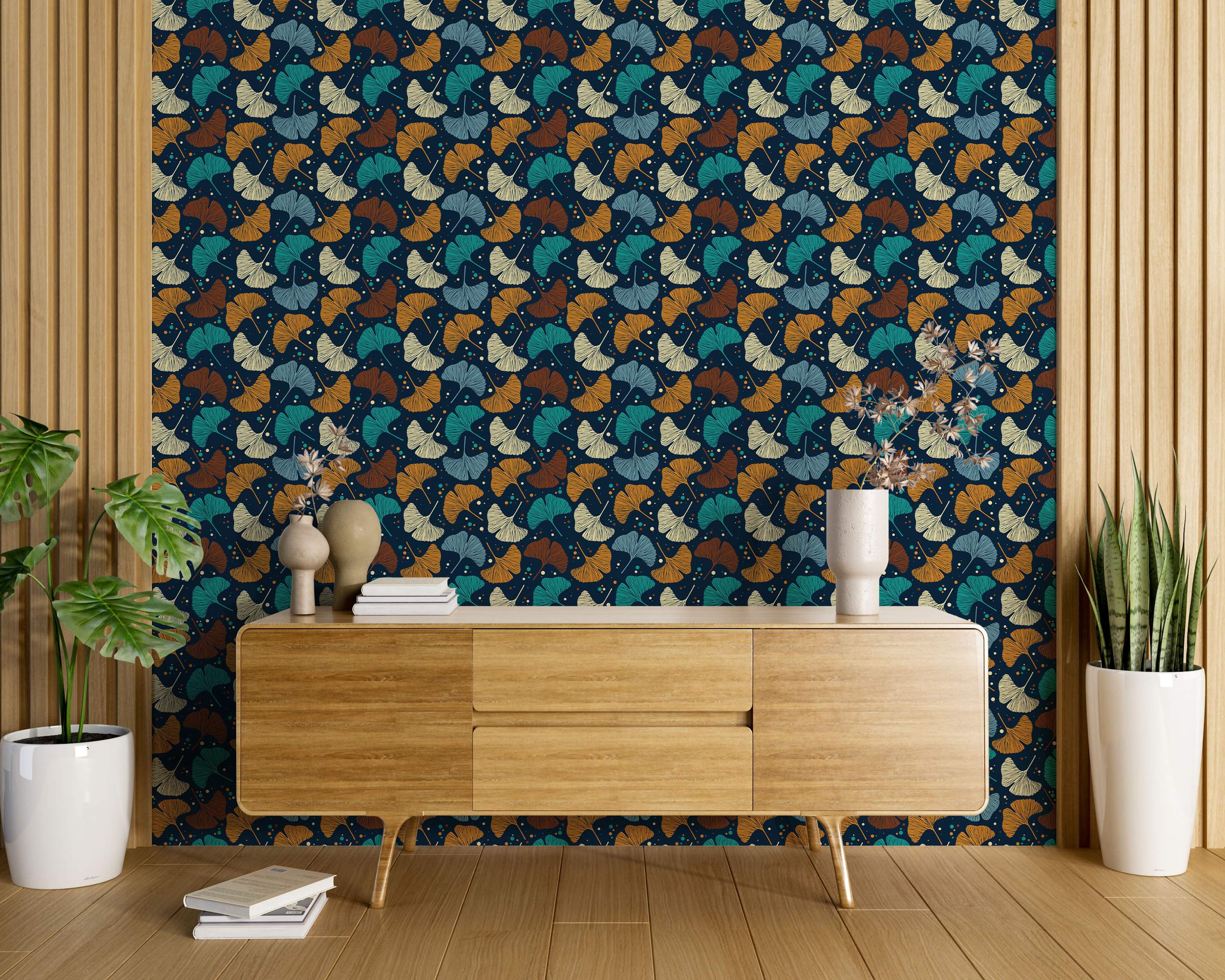 Wallpaper featuring a pattern of stylized ginkgo leaves in teal, light blue, brown, and cream on a dark blue background.