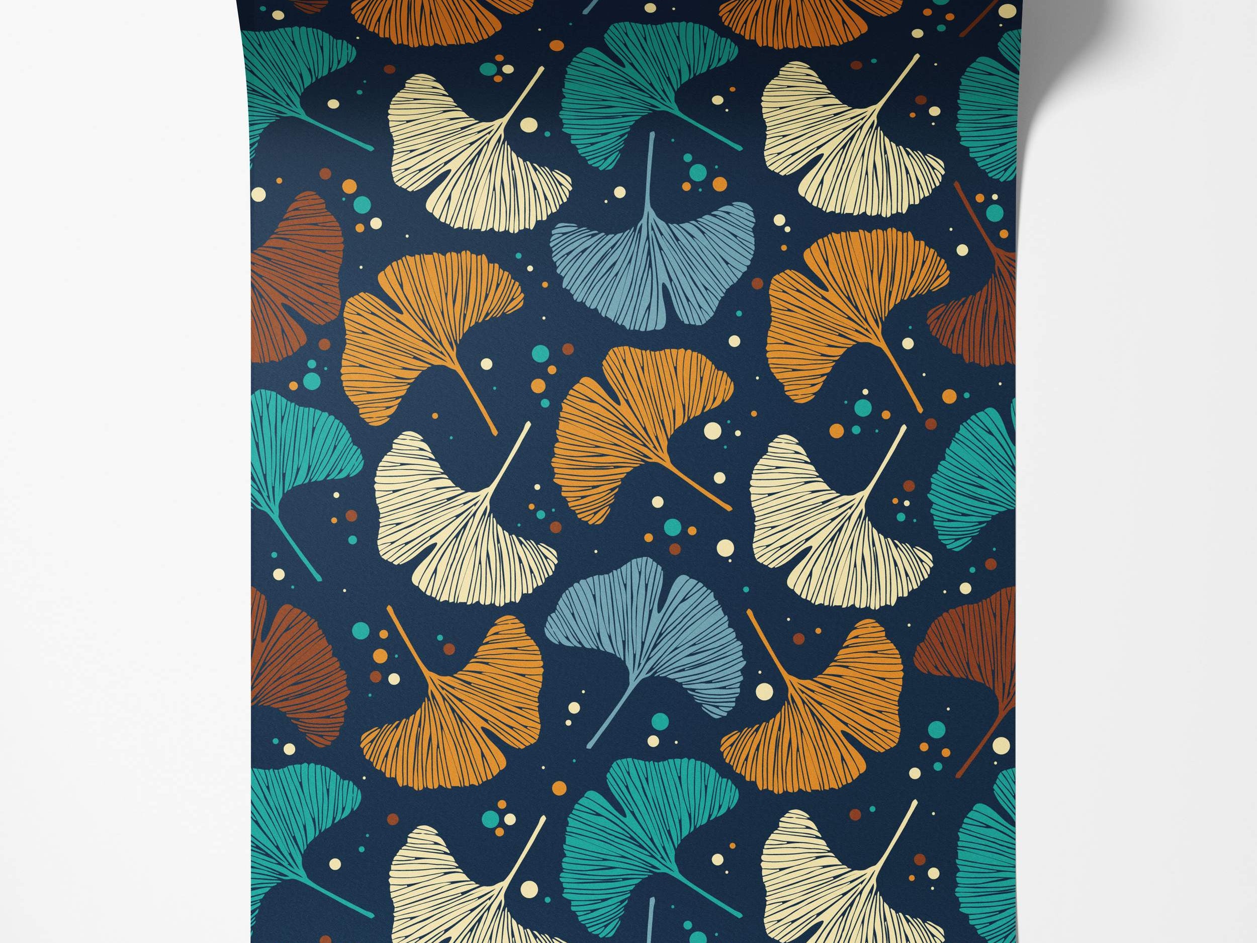 Wallpaper featuring stylized ginkgo leaves in teal, orange, brown, beige, and light blue scattered on a dark navy blue background.