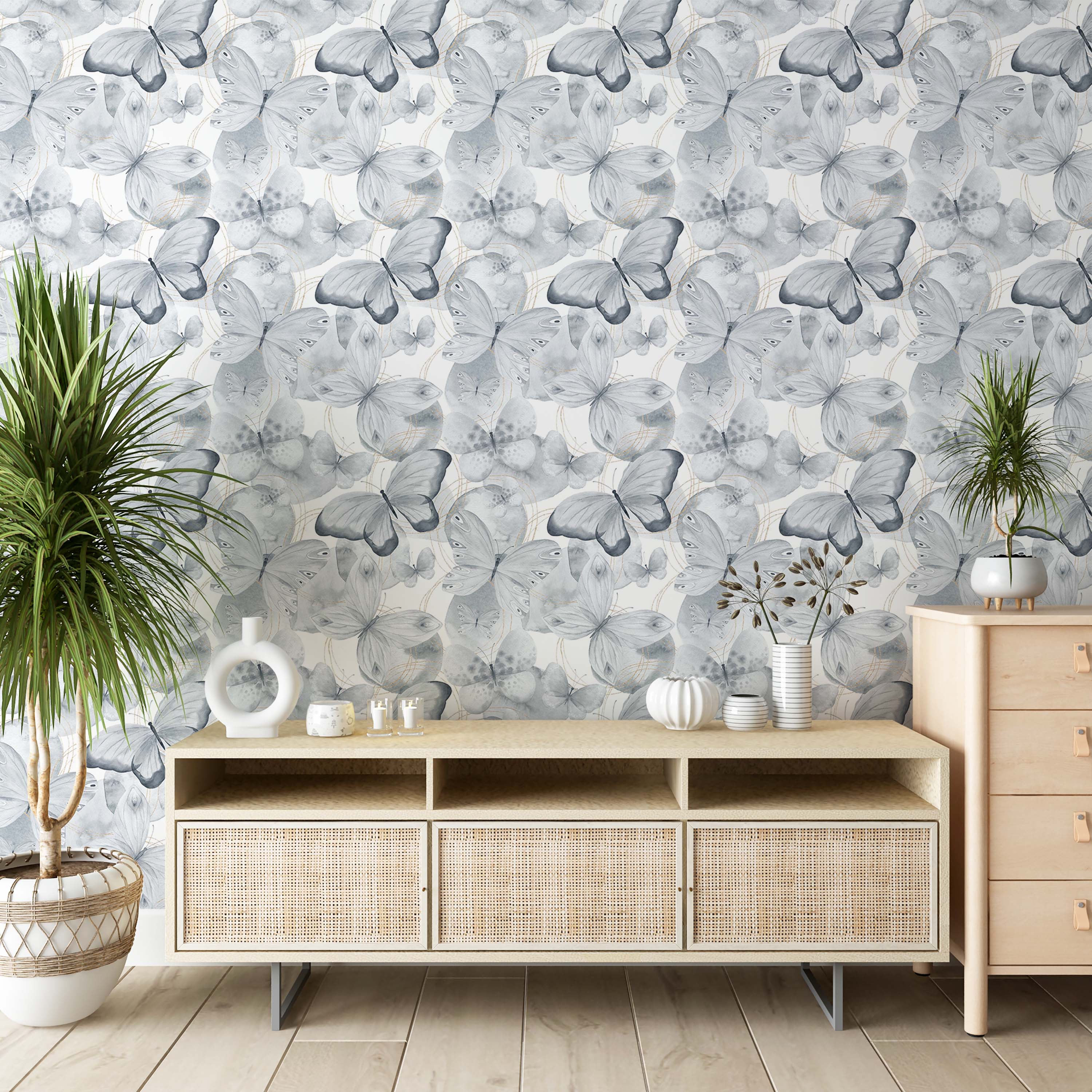 A repeating wallpaper pattern of delicate watercolor butterflies in various shades of gray, accented by fine gold circular lines.