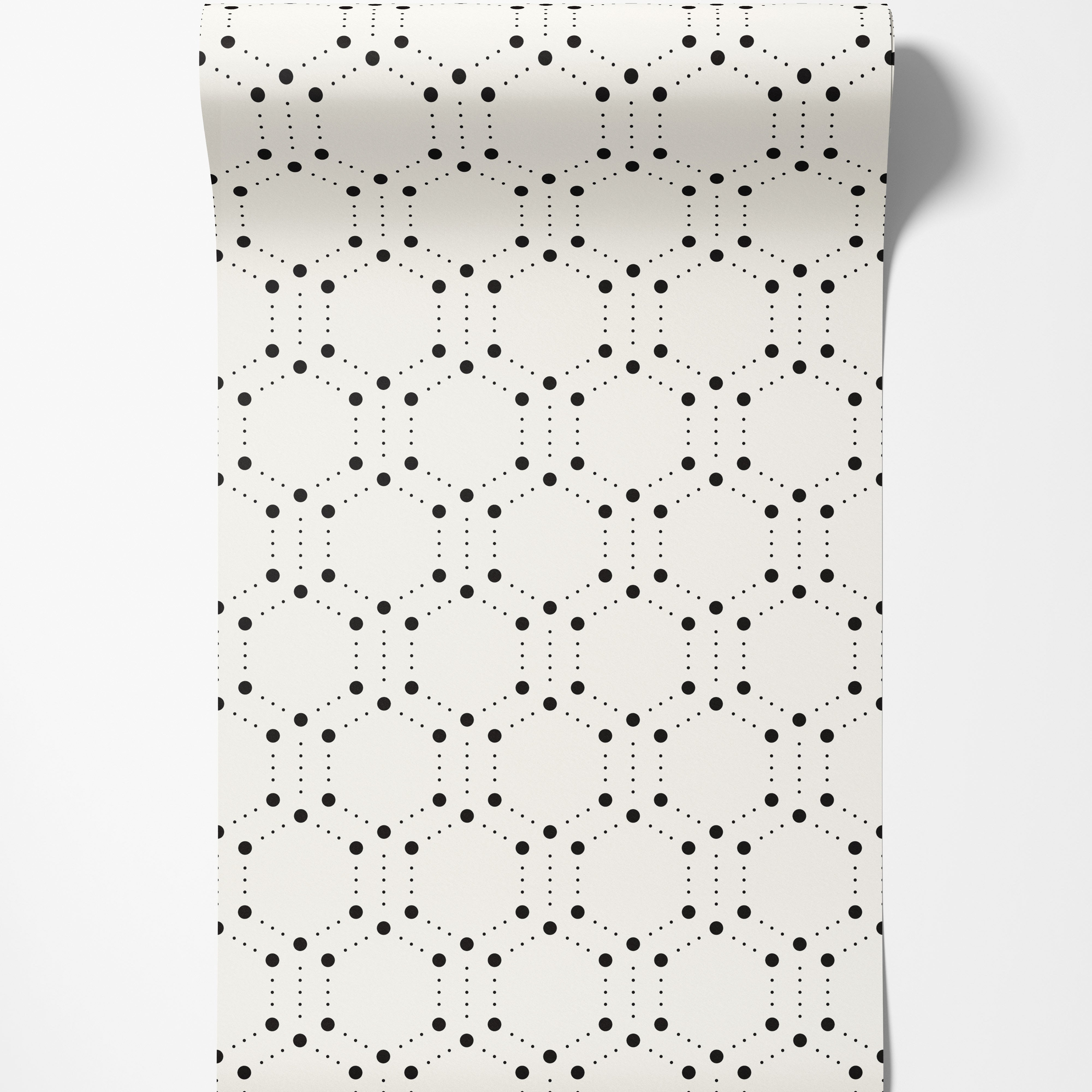 Geometric wallpaper featuring hexagons outlined by large and small black dots on a cream background.